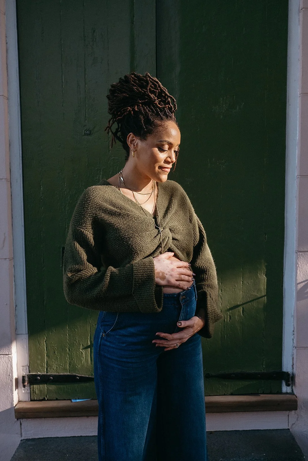 Maternity portrait against a French Quarter backdrop in New Orleans.