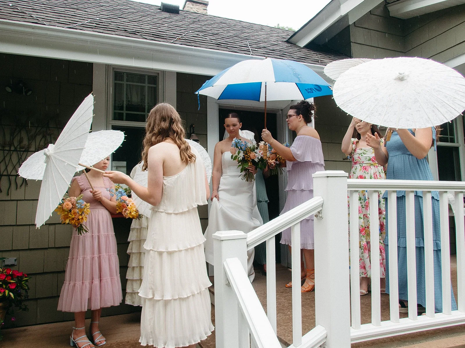 The bridal party hiding the bride from view on her wedding day.