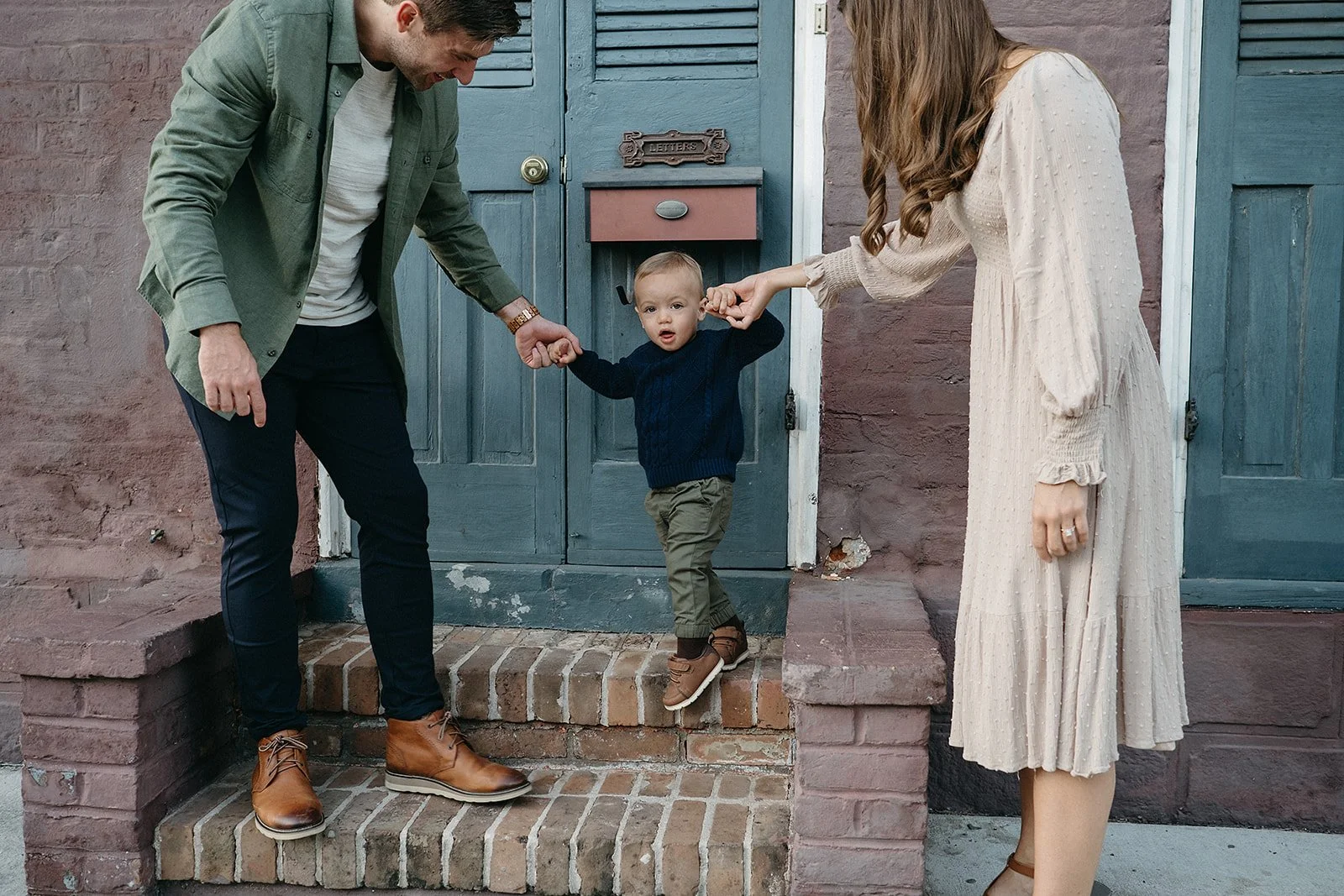 Family holding hands during family photo session in the French Quarter, New Orleans
