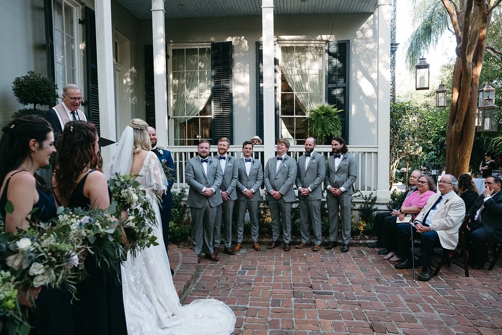 Wedding Party watching bride and groom getting married at Terrell House Bed & Breakfast in the Lower Garden District in New Orleans
