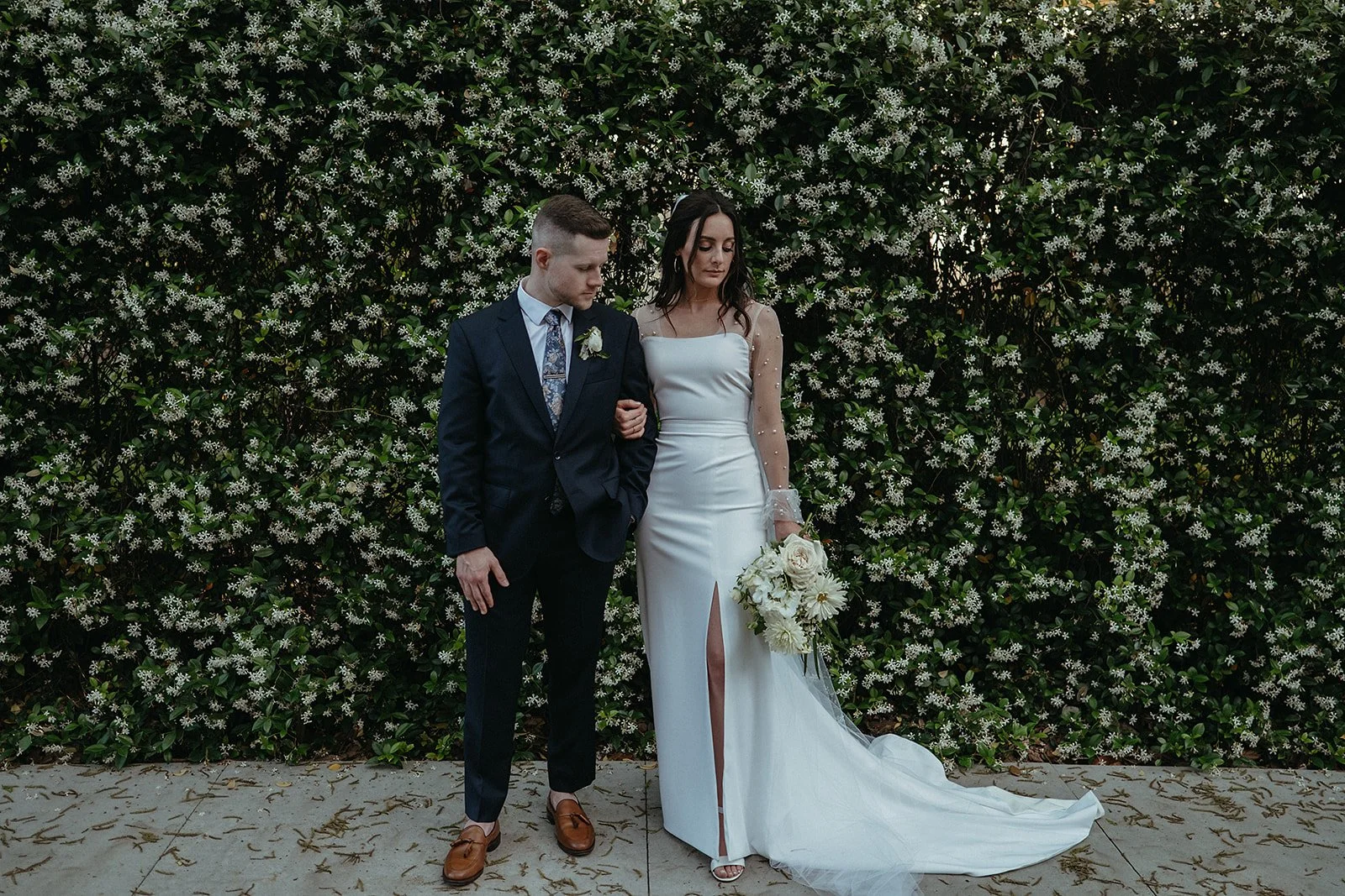 bride and groom portraits against the blooming Jasmine on St. Charles Ave in New Orleans