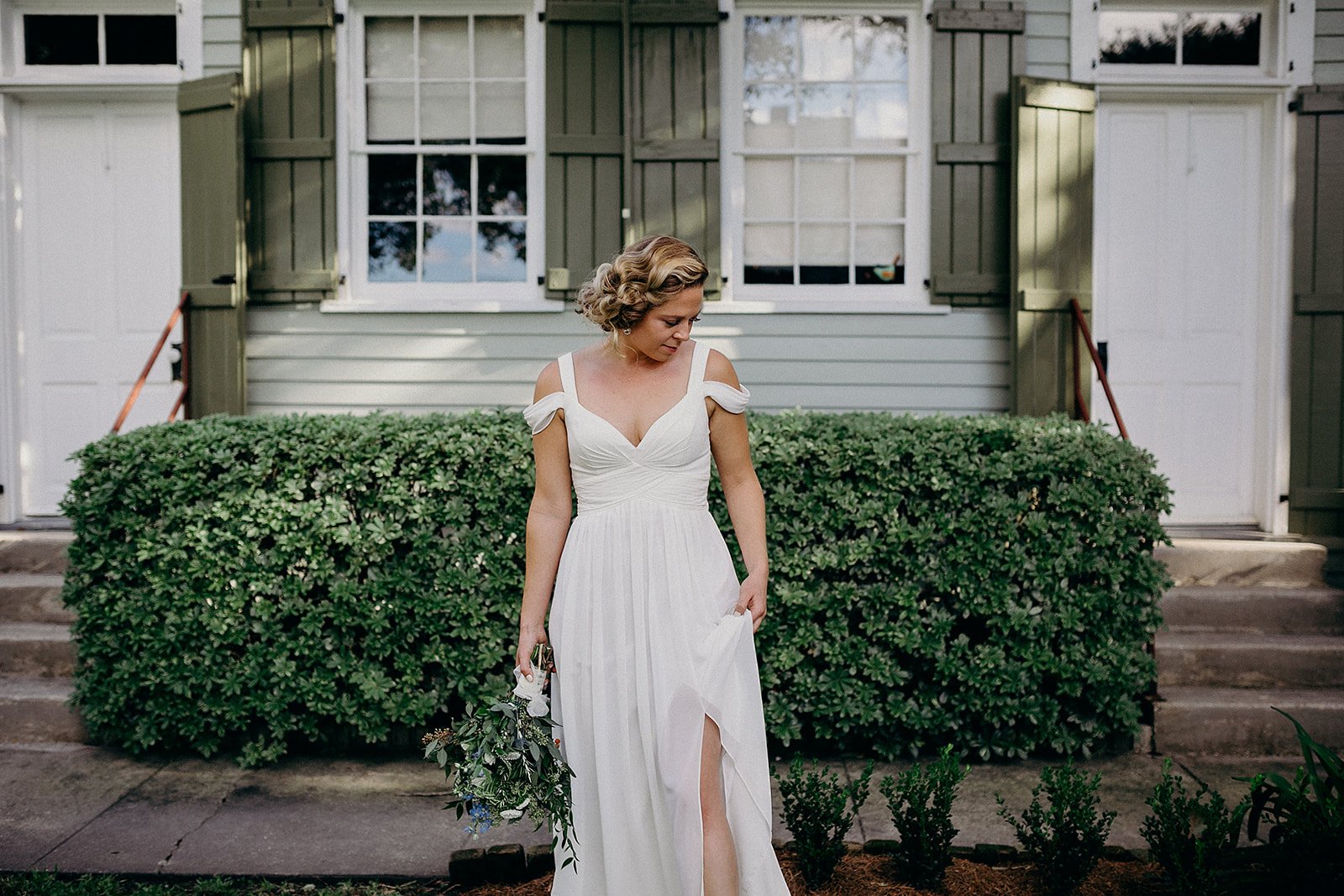 Bride checking her dress before walking down the aisle on her wedding day in New Orleans
