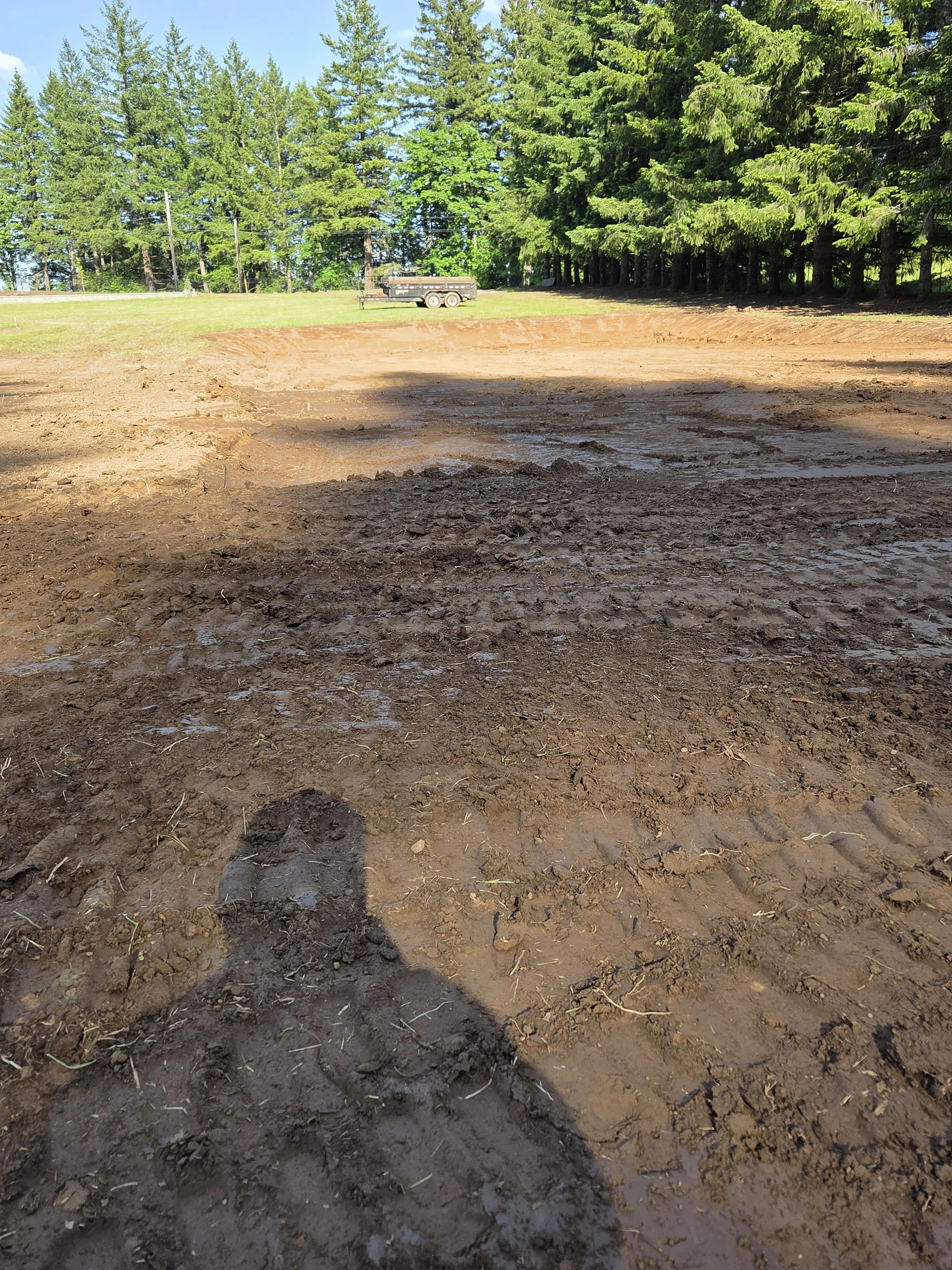 Clearing trees and grading a flat space for site preparation — land clearing and site prep | North Woods Tree Service