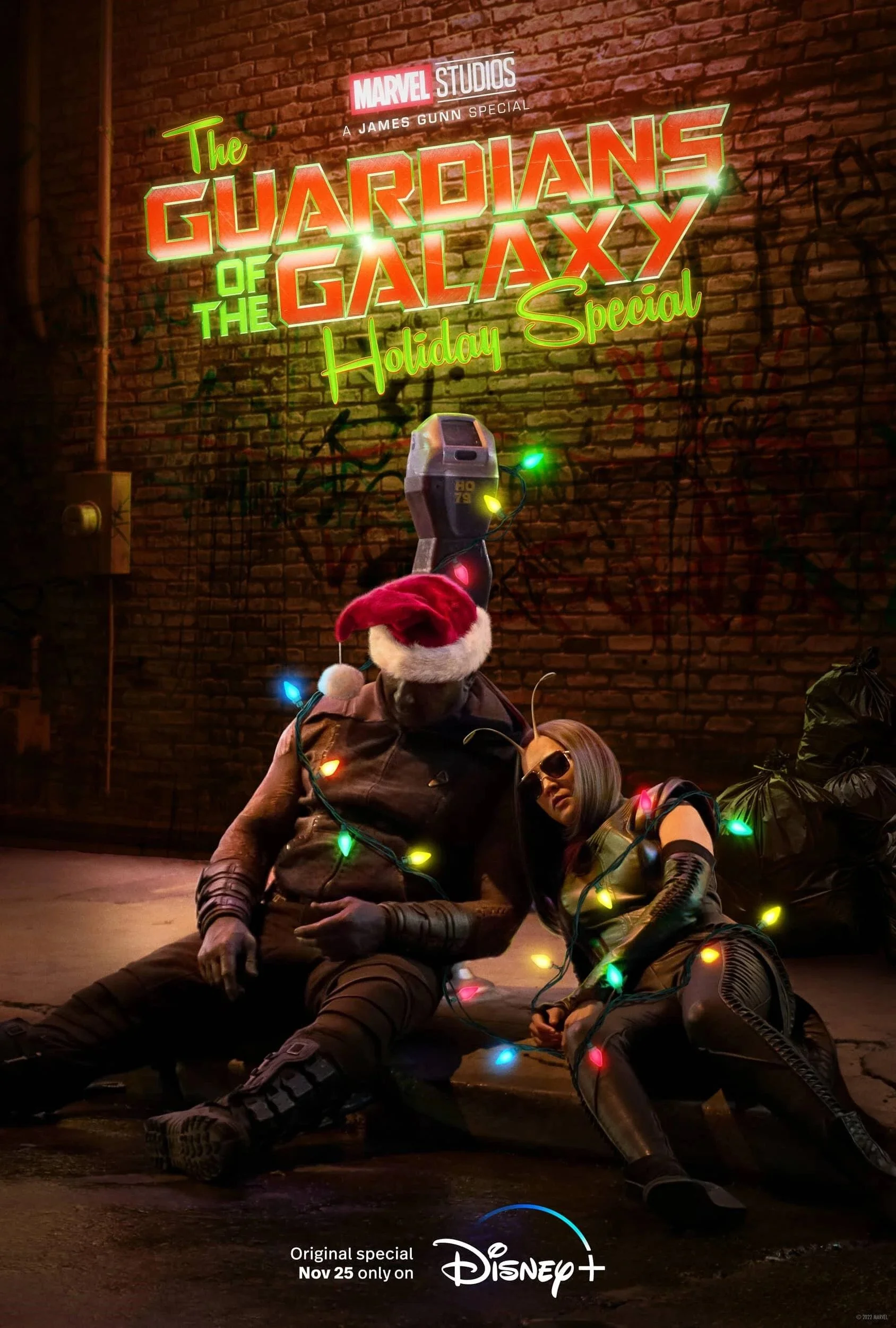 Two characters dressed as Marvel's Guardians of the Galaxy sitting against a brick wall decorated with colorful holiday lights. They are under a neon sign for "The Guardians of the Galaxy Holiday Special" with additional text mentioning Disney+ and a special release date of November 25.