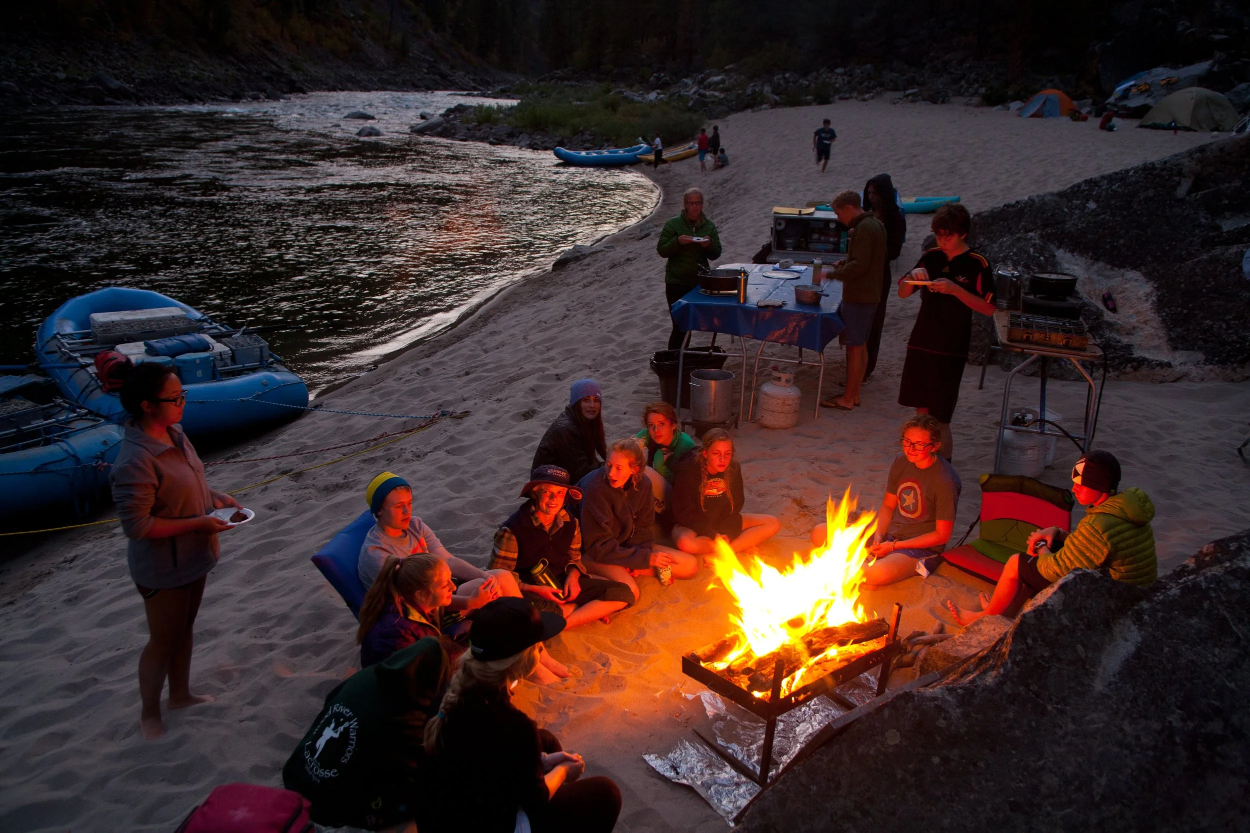 Enjoying a campfire and games with Nomad Whitewater Experience in Idaho.