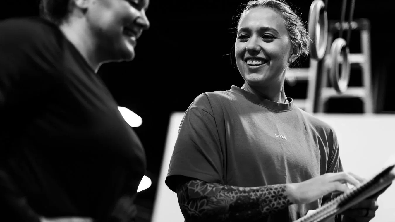 Kait Taylor, founder of Origin Wellness, reviewing a client's progress during a personalized personal training session in Washington, DC.