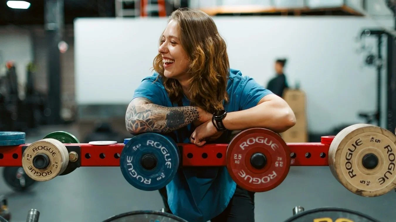 Founder of Origin Wellness, Kait Taylor, in a Washington, DC gym dedicated to helping clients build strength, improve mobility, and move with confidence.