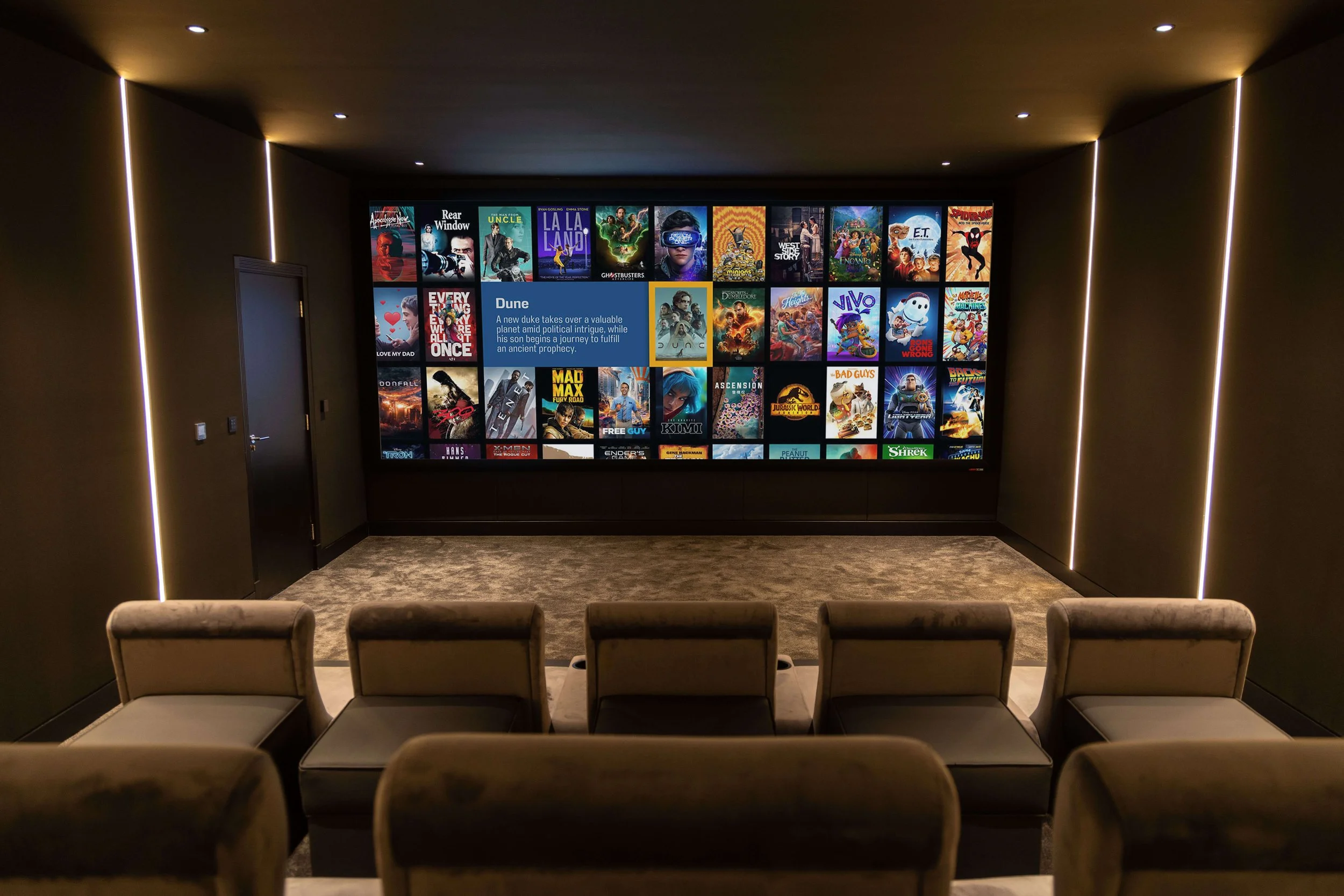 Home theater room with a large wall-mounted screen displaying streaming movies, six beige chairs in the foreground, dark walls with vertical LED light strips, and a carpeted floor.