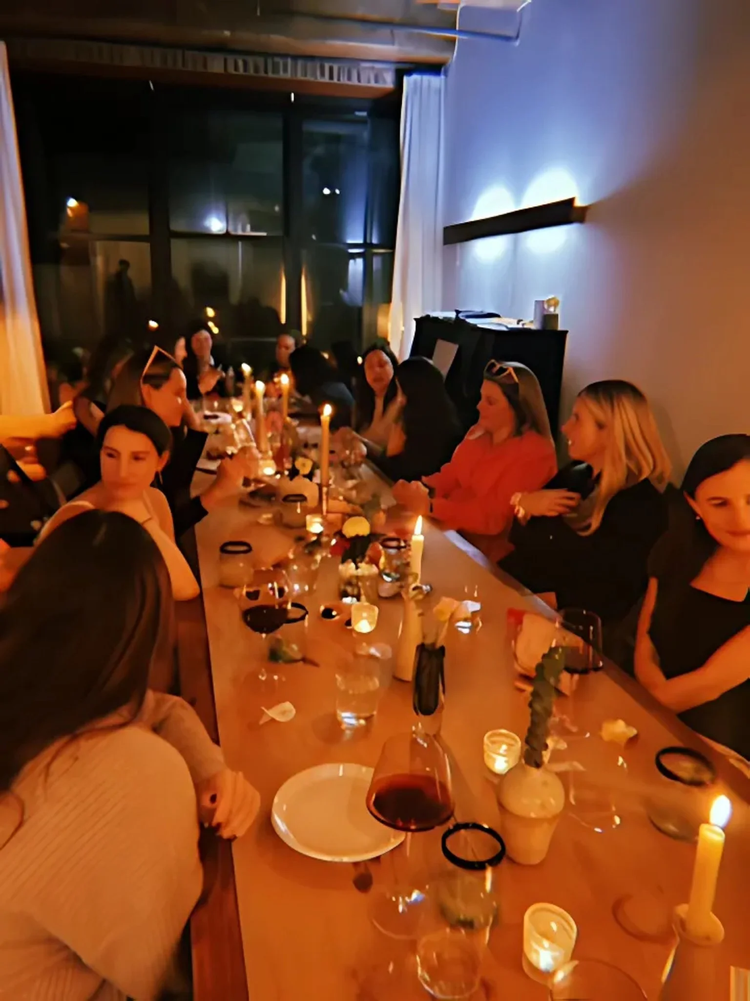 Handmade folding farm table with vintage wooden folding chairs set for a bachelorette party dinner in a Greenpoint Brooklyn loft.