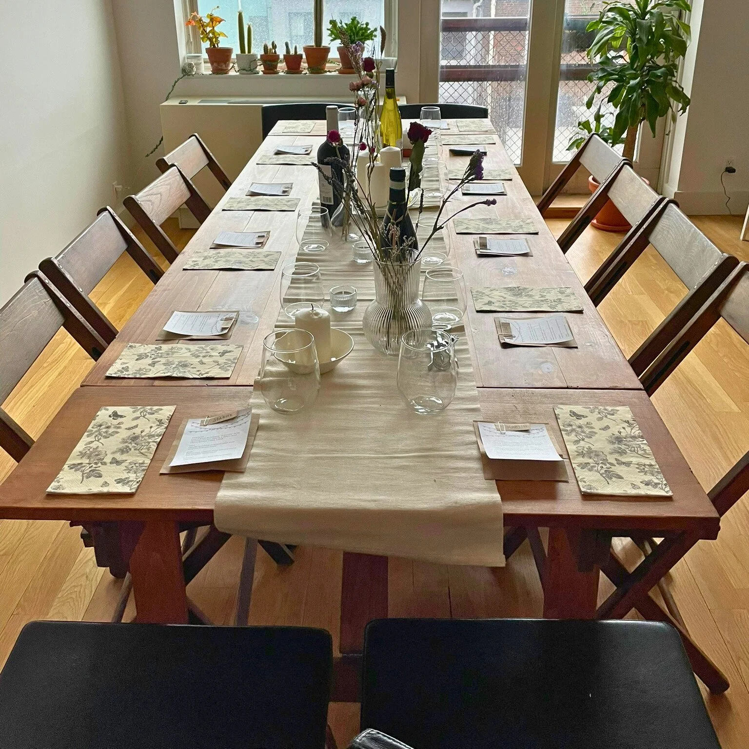 KRAUS folding farm table with end extension leaves, fully set for a long dinner