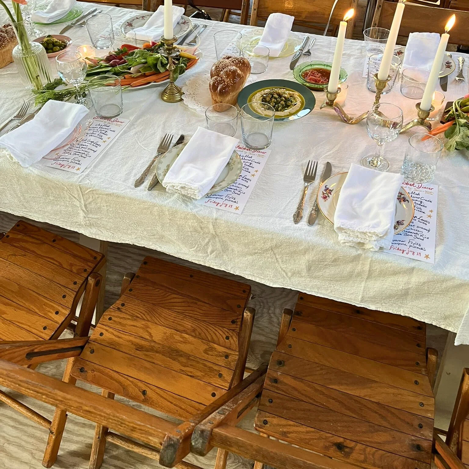 KRAUS light-finish vintage wooden folding chairs at a long dining table