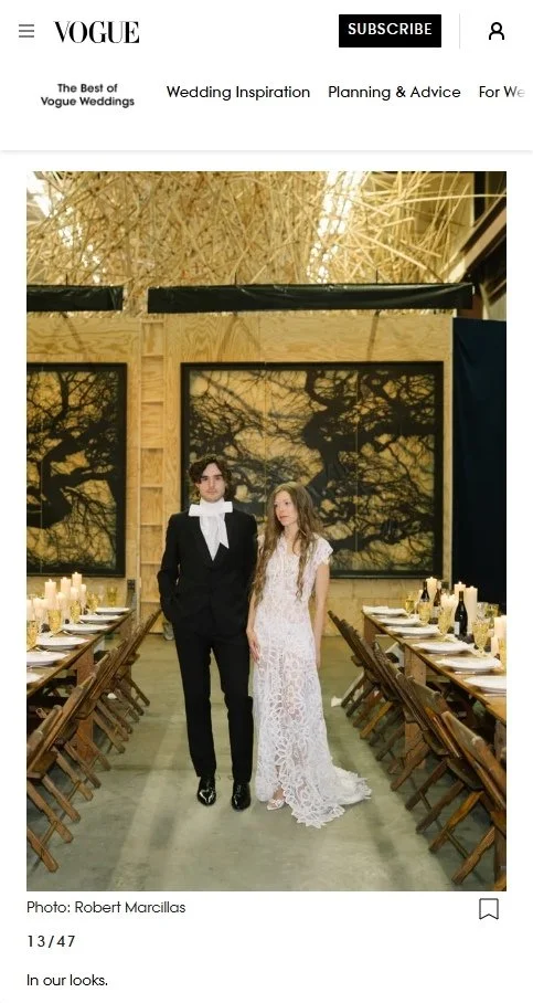 Best of Vogue feature of Kraus' handmade folding farm tables and vintage wooden folding chairs arranged behind bride and groom at the wedding of Paris Starn
