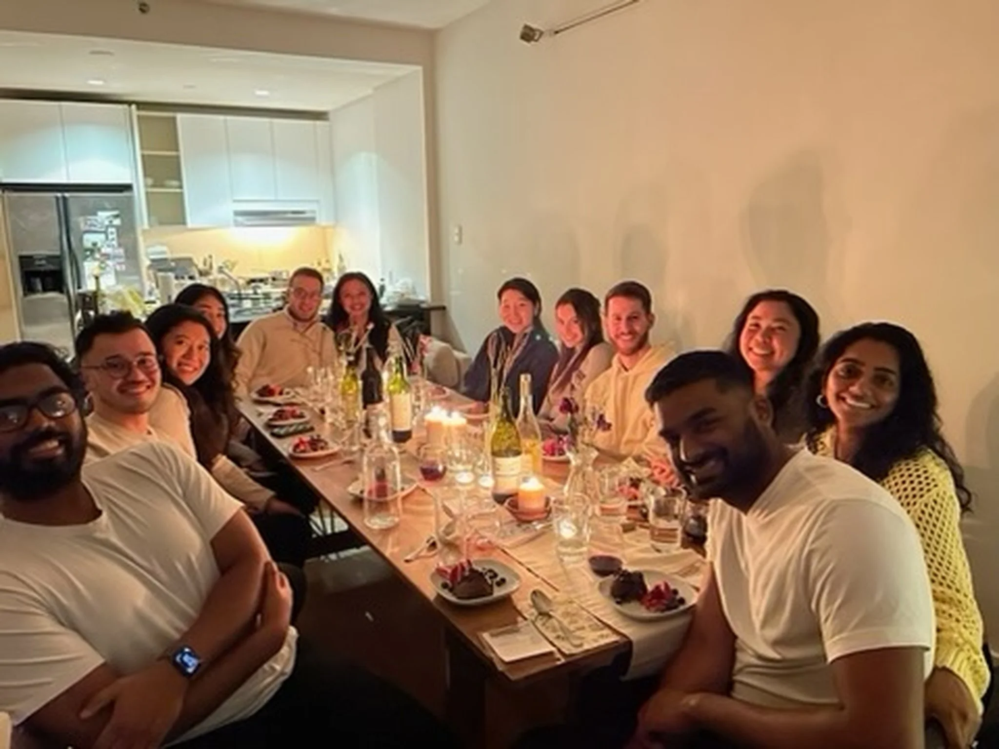 Handmade folding farm table with vintage wooden folding chairs set for a birthday dinner in a Bushwick Brooklyn apartment.