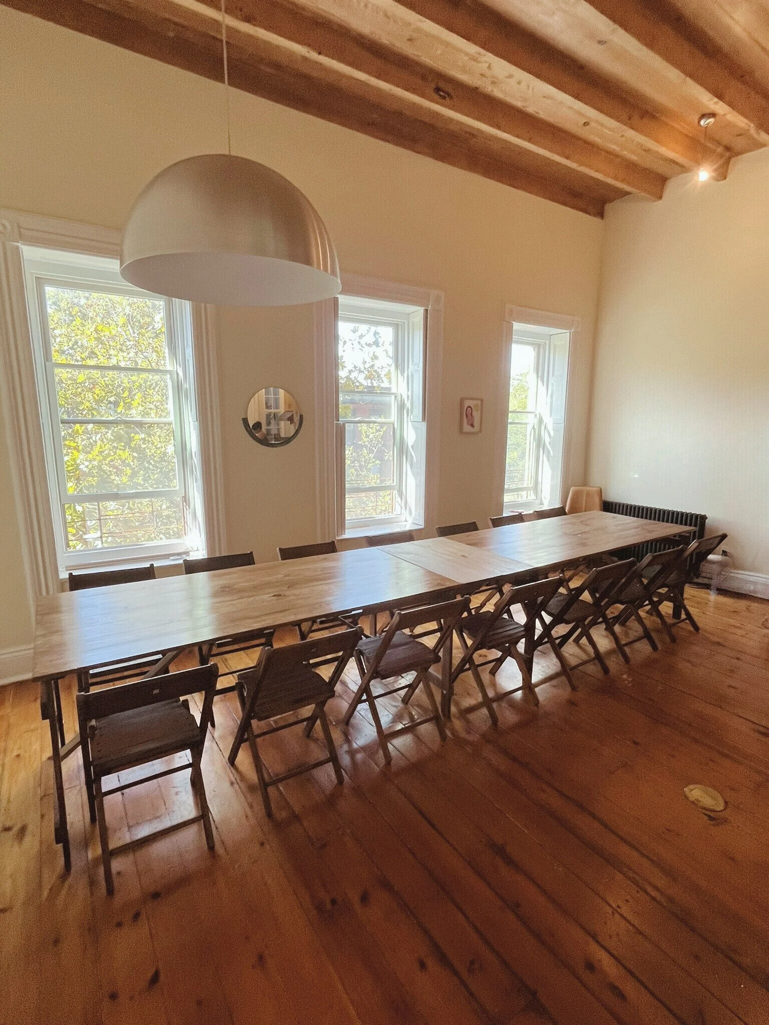 Handmade folding farm table with vintage wooden folding chairs set for a baby shower dinner in a Park Slope Brooklyn brownstone.