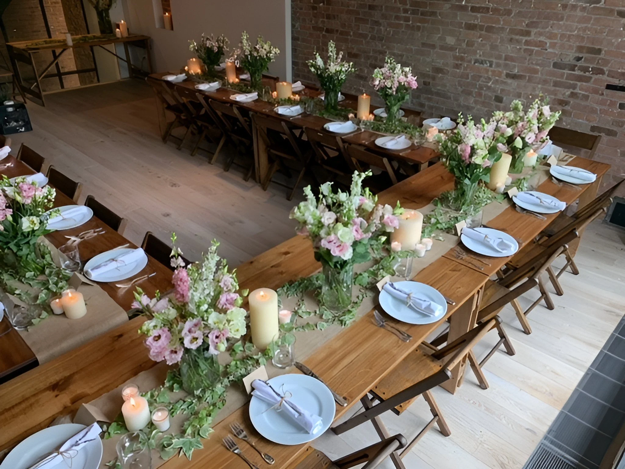Handmade folding farm tables with vintage wooden folding chairs set for a birthday lunch in a Tribeca townhouse dining room.