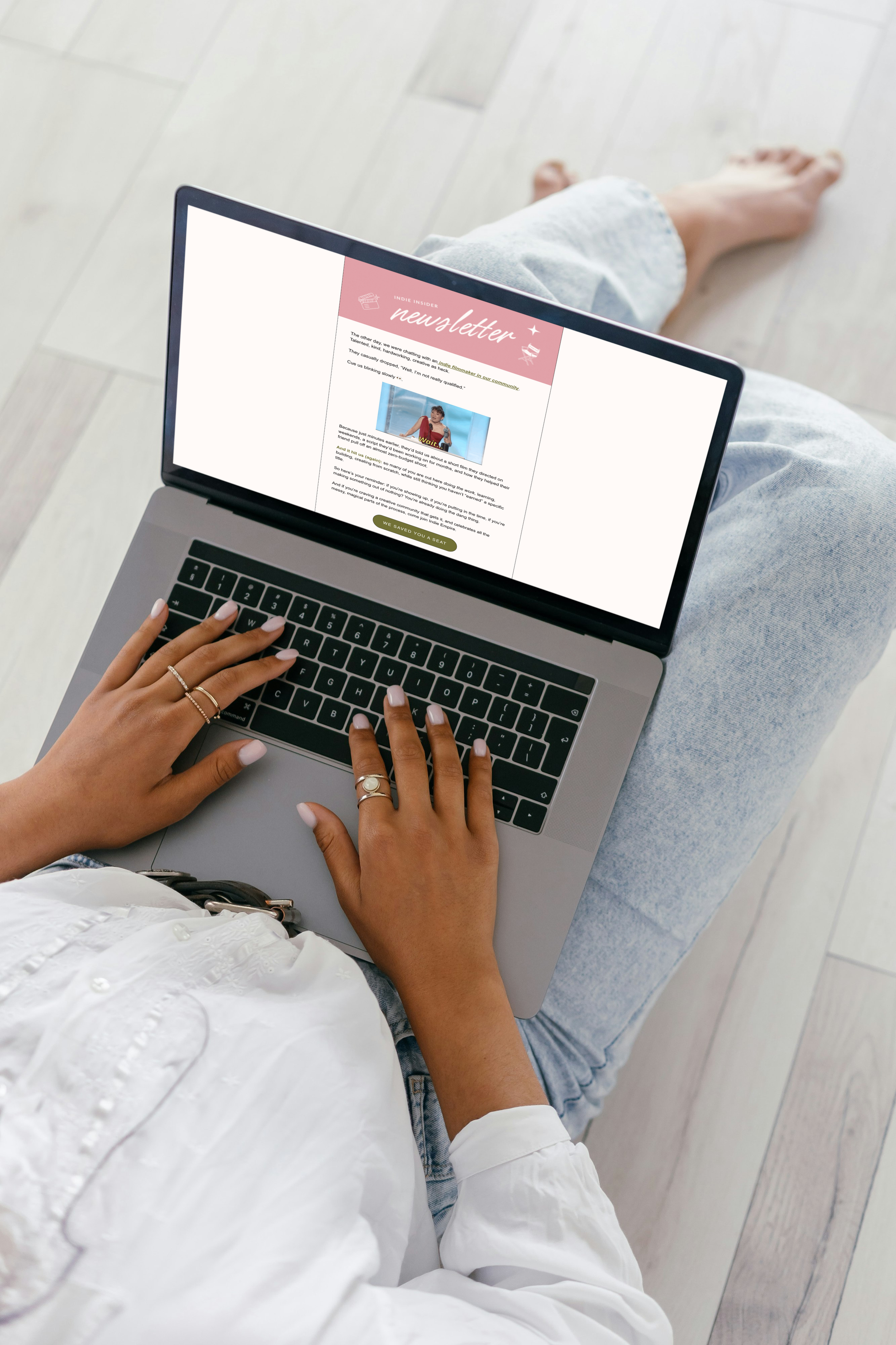 A person reads the Indie Insider Newsletter on a laptop, displaying an issue about indie filmmakers and community.