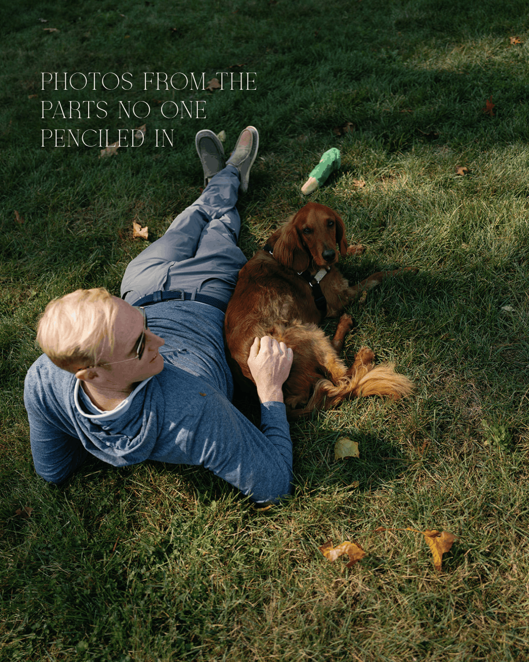 A wedding guest lies in the grass petting a long-haired dachshund, with text: 'Photos From the Parts No One Penciled In.