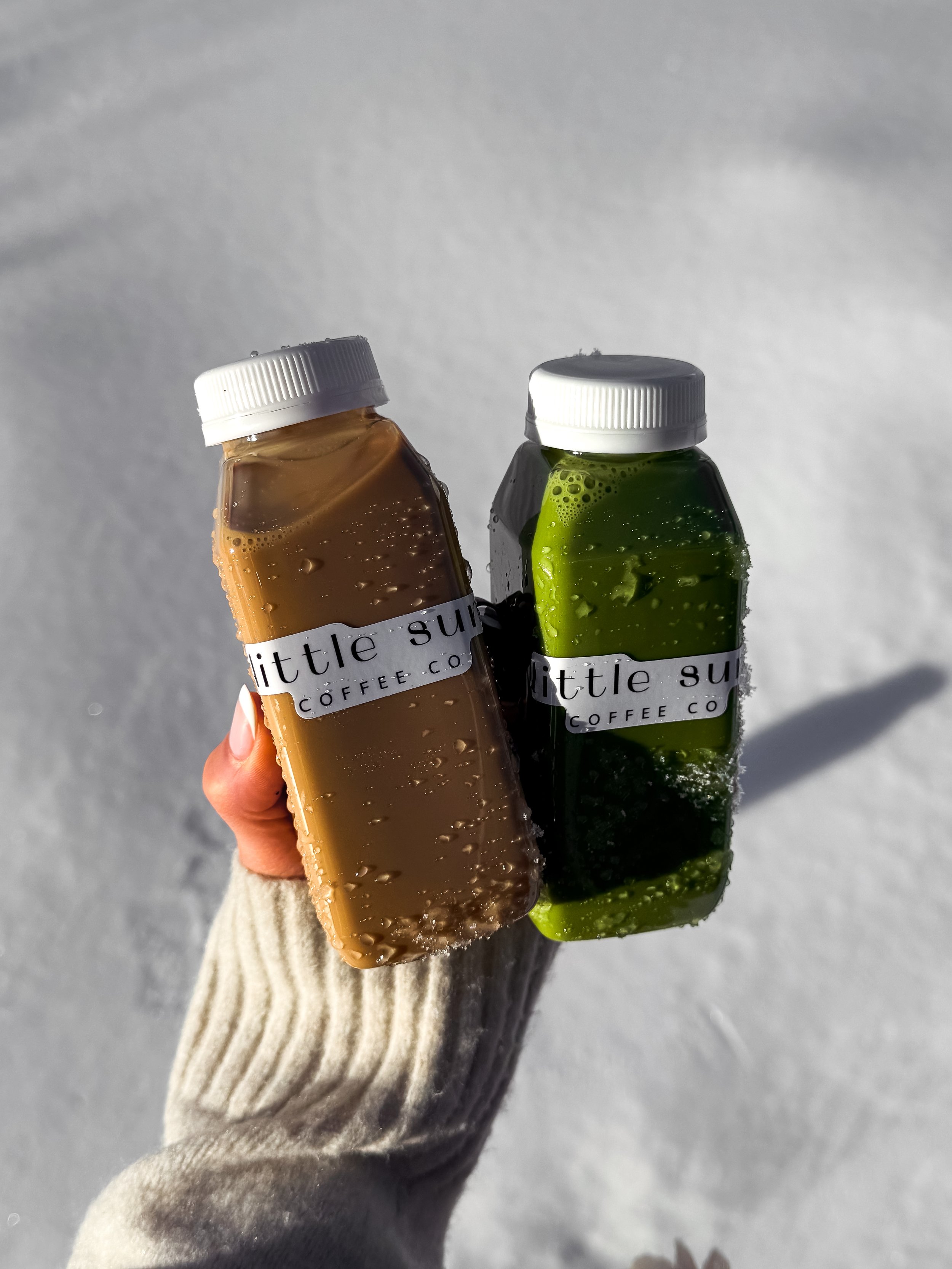 Barista crafting bottled lattes with coffee latte and matcha latte with Philadelphia Coffee cart catering