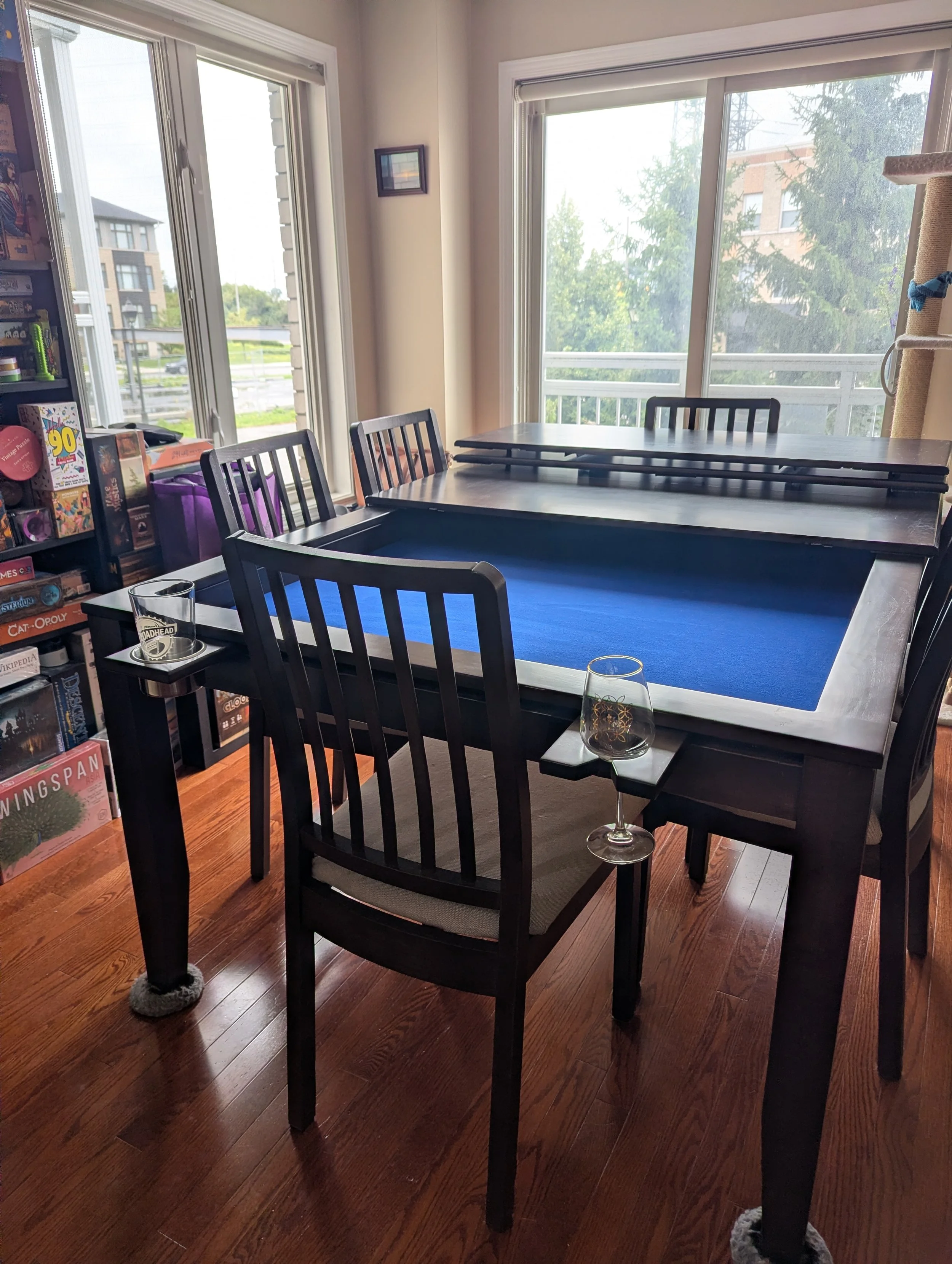 A view from the head of this sleek stained game table with chairs and accessories installed on the magnetic game rail