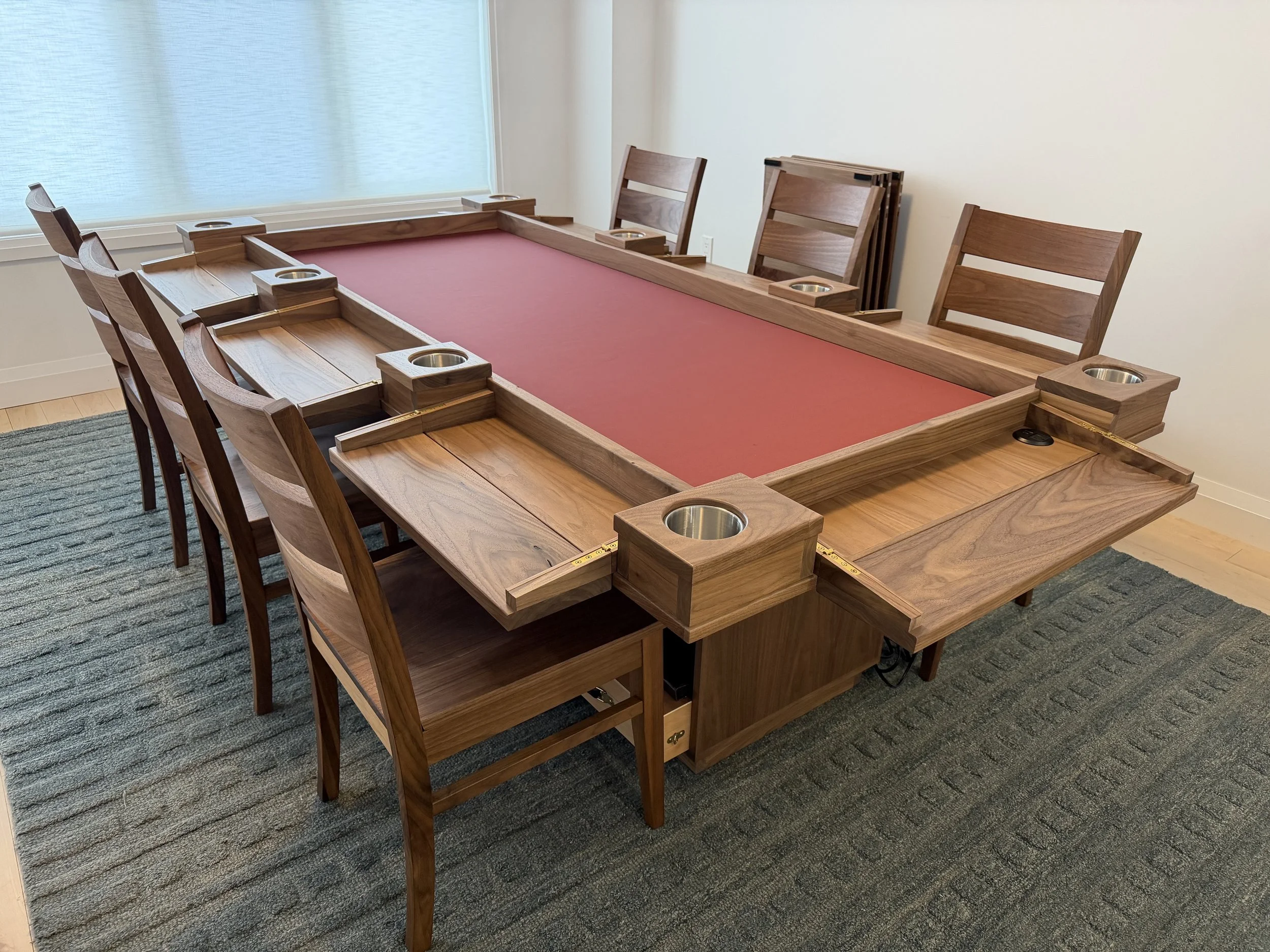 corner view of a player station game table with all player station folded out with chairs at each station 