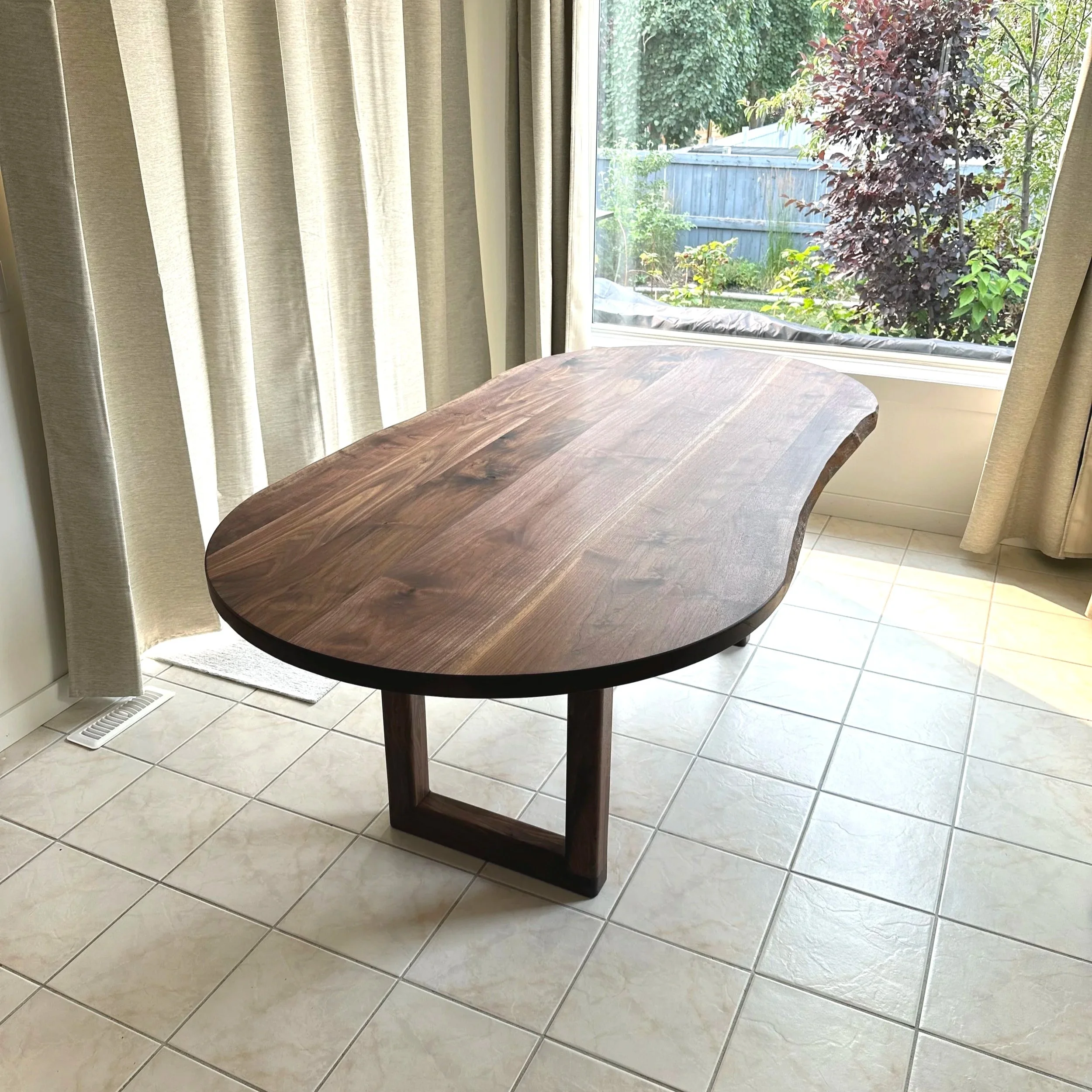 Corner view of a walnut dining table with live edges 