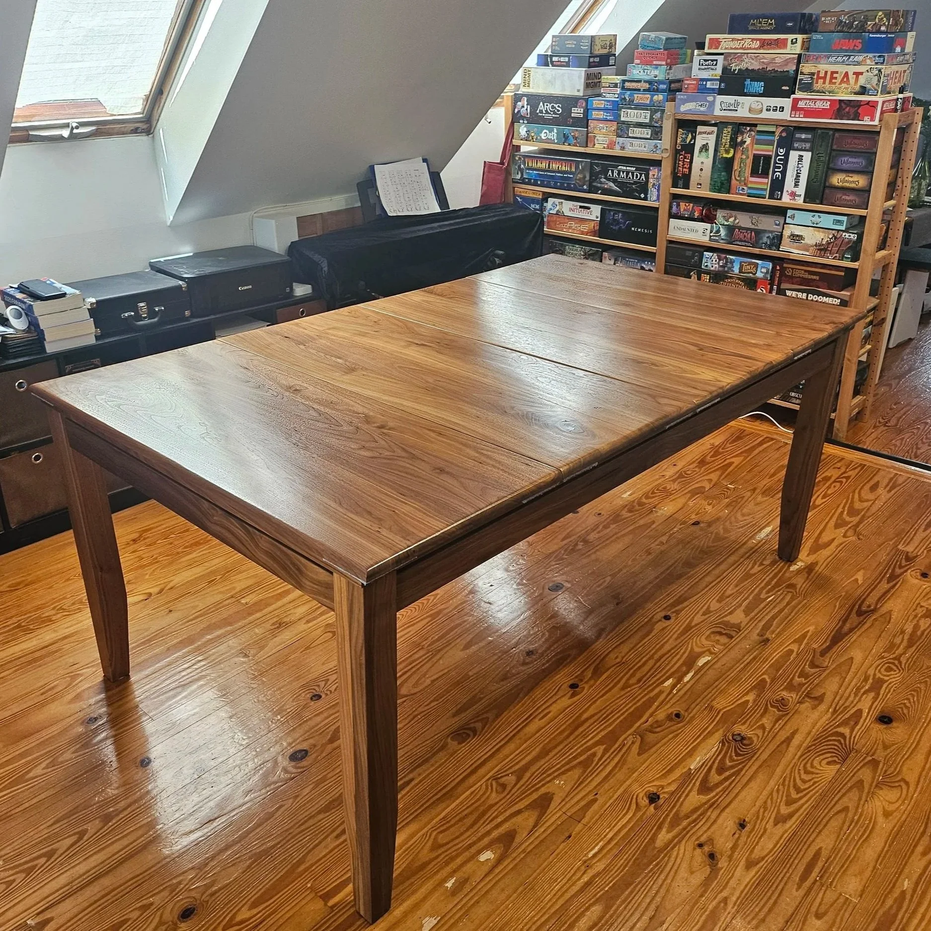 Corner view of a walnut game table with topper panels installed 