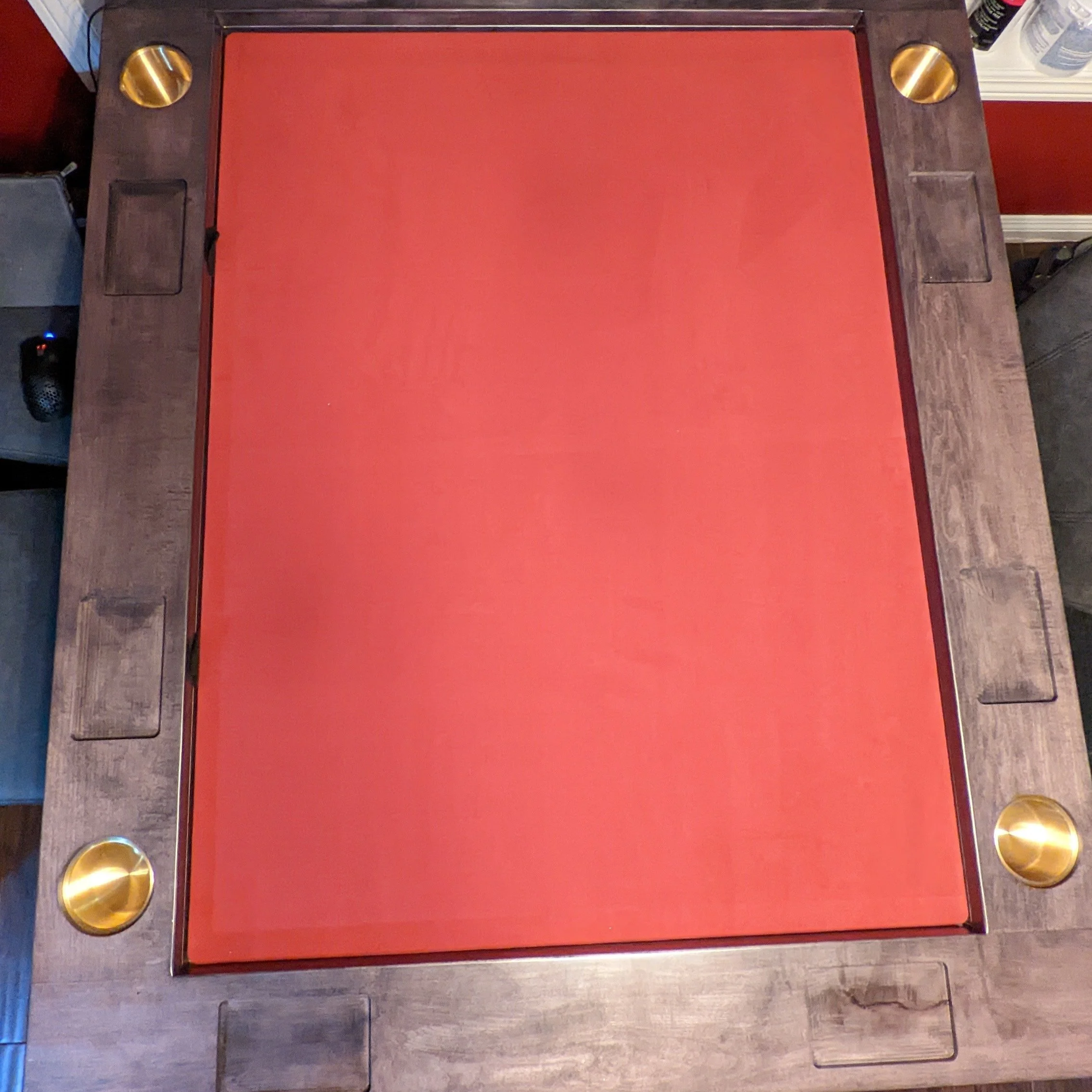 A top down view of game table with a red neoprene playing surface