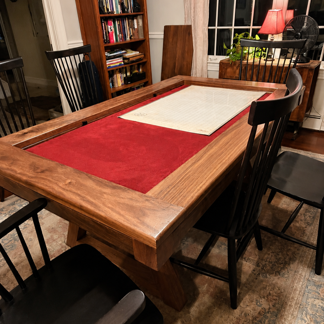 Zoomed in view of the corner of the game table showcasing the burgundy rolling mat and the walnuts figure
