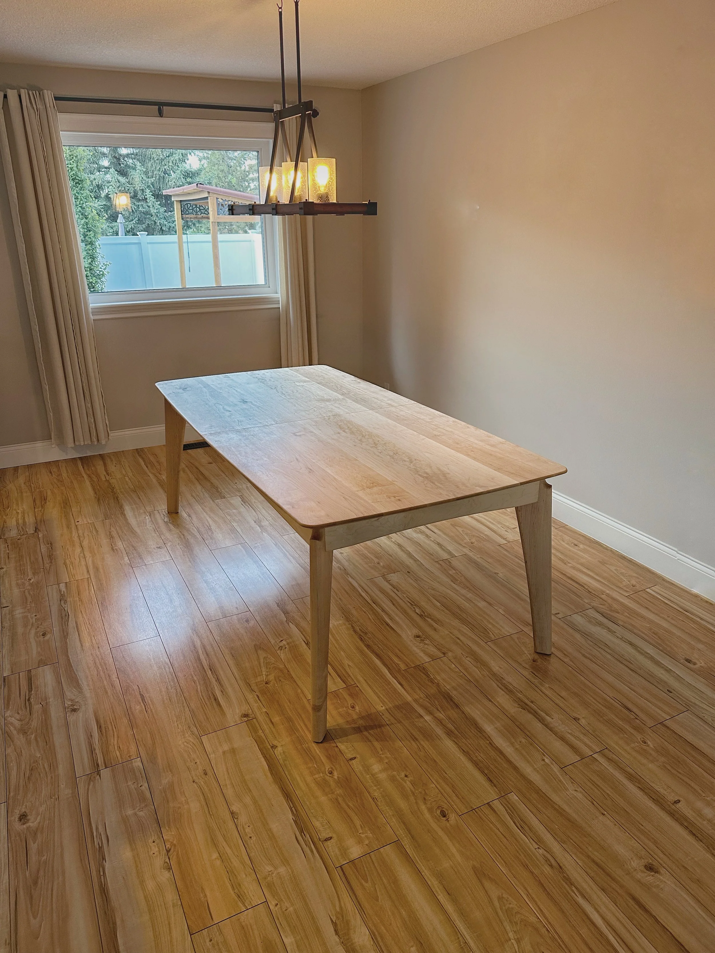 A maple table showcased in the middle of the dining room 