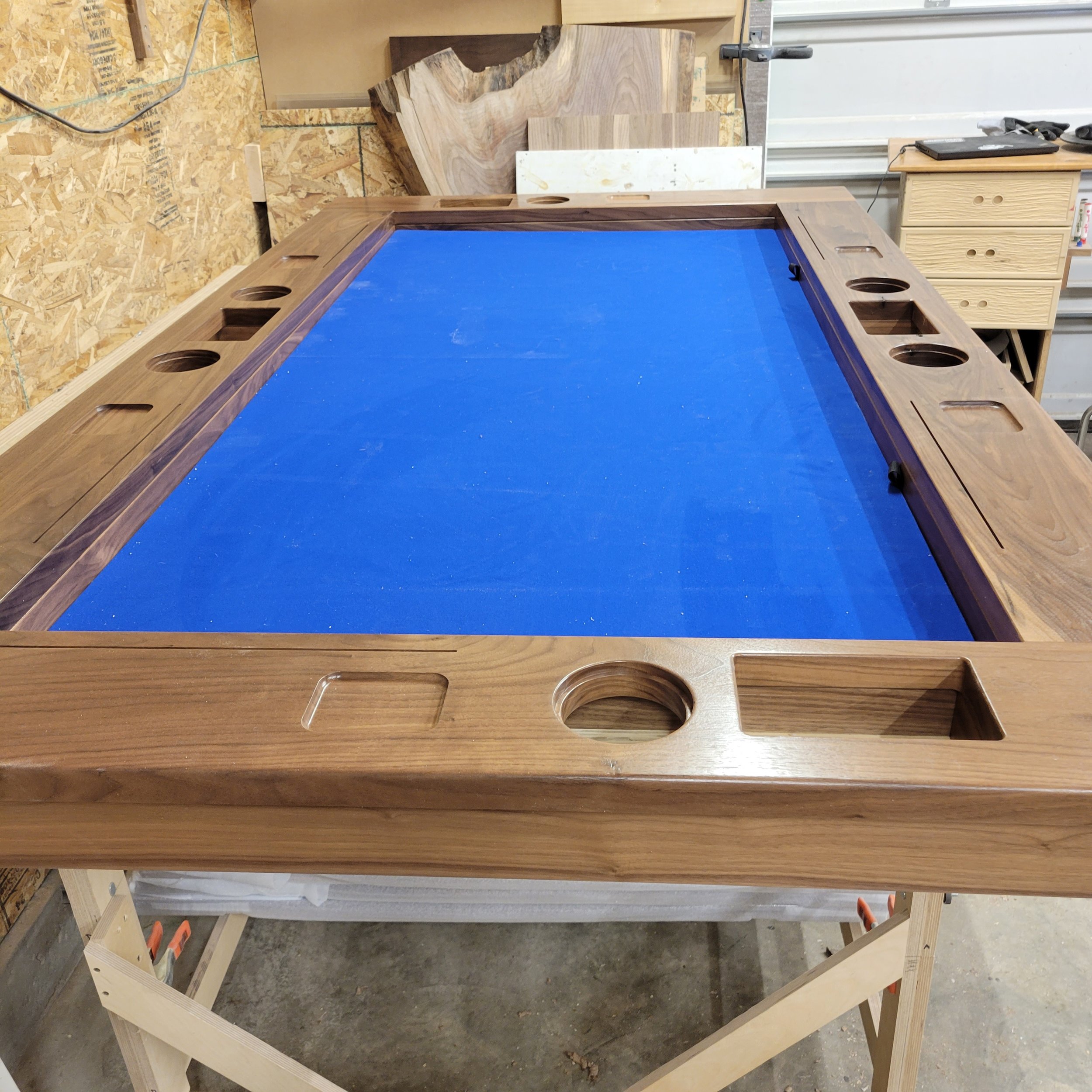 In progress photo of a walnut board game table with integrated dice bin storage, cup holders and component trays