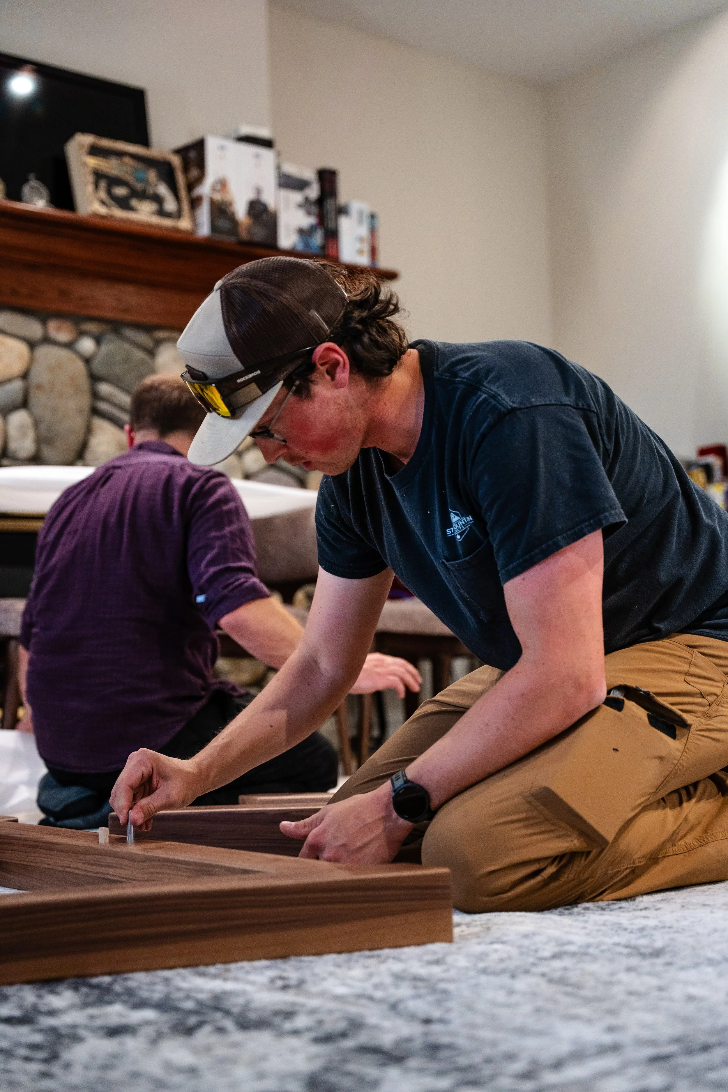 Owner of Stone Mountain Projects Harley Griffin assembling a table base