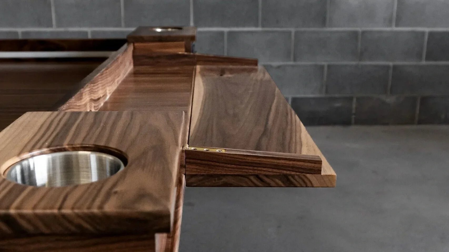 Detailed view of a game table player station folded out and read for game play with cup holders on each side