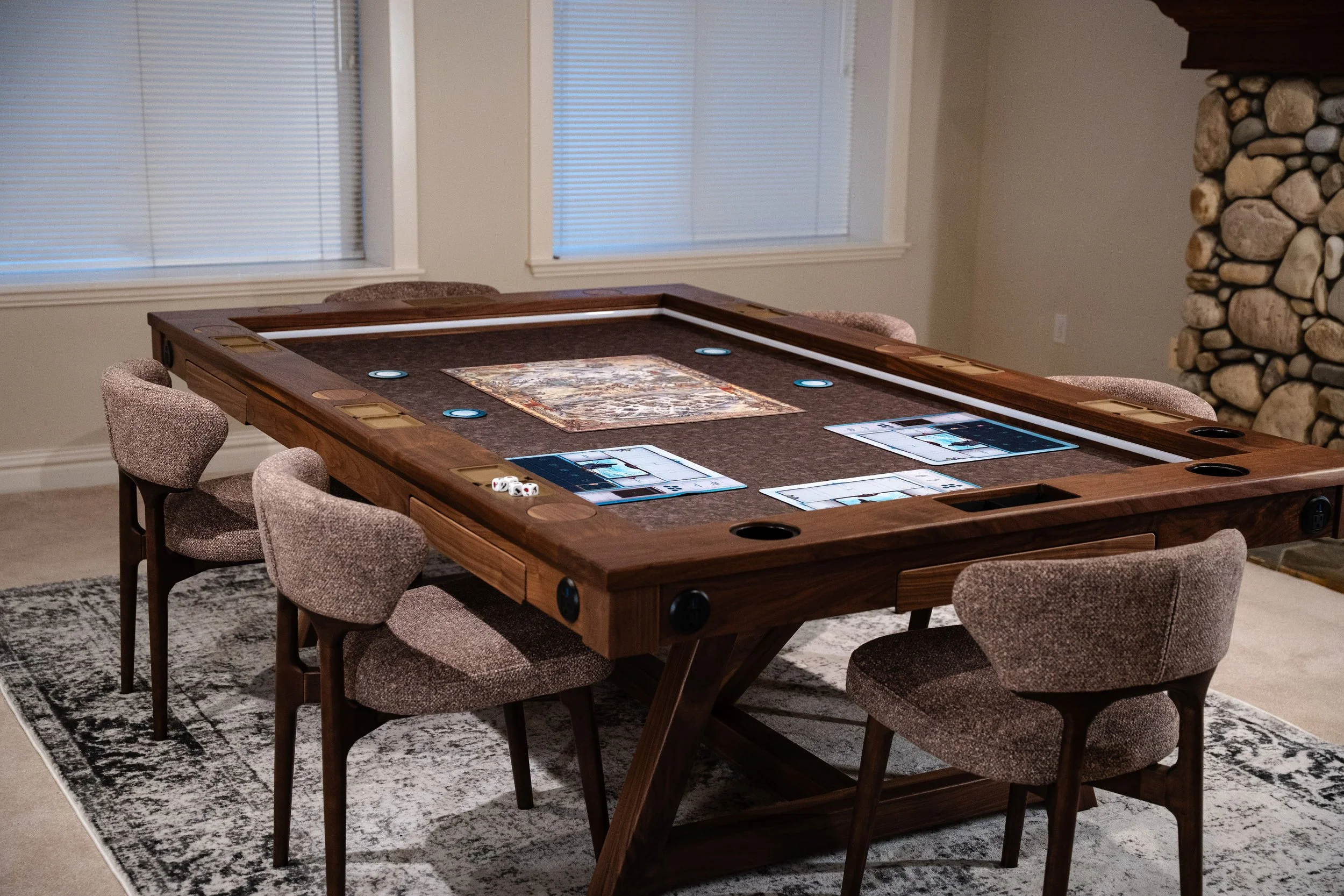 Wide angle shot of a walnut game table with chairs and a game setup in the middle