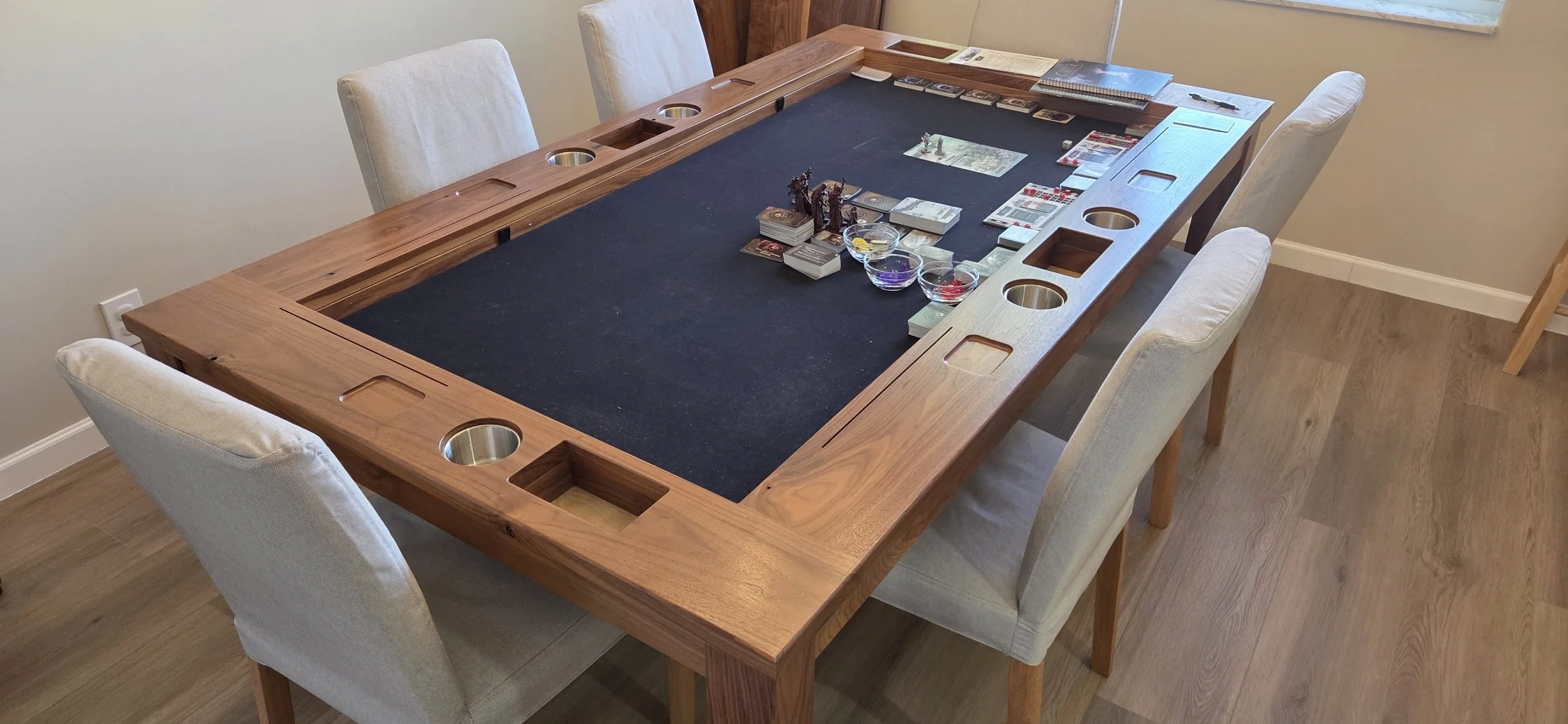 high angle corner view of a wide armrest game table with internal armrest storage and organization