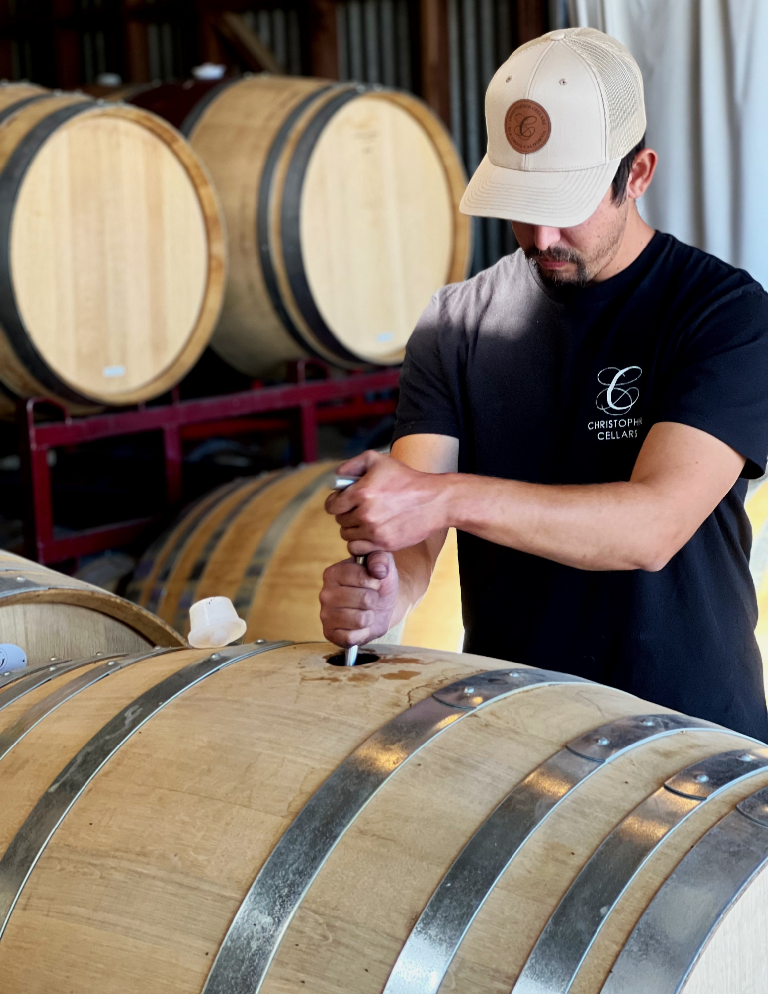 Christopher Mora, Owner and Winemaker of Christopher Cellars, performing bâtonnage to build texture and complexity in wine aged in French oak puncheon barrels from TN Coopers.