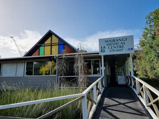 Exterior of Marangi Medical Centre building with a colorful triangular roof and a ramp leading to the entrance