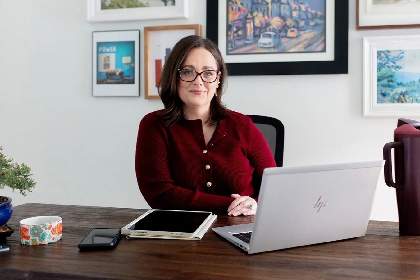 Sheryl Ford, LMFT and LPC, Louisiana trauma and couples therapist seated at her office desk