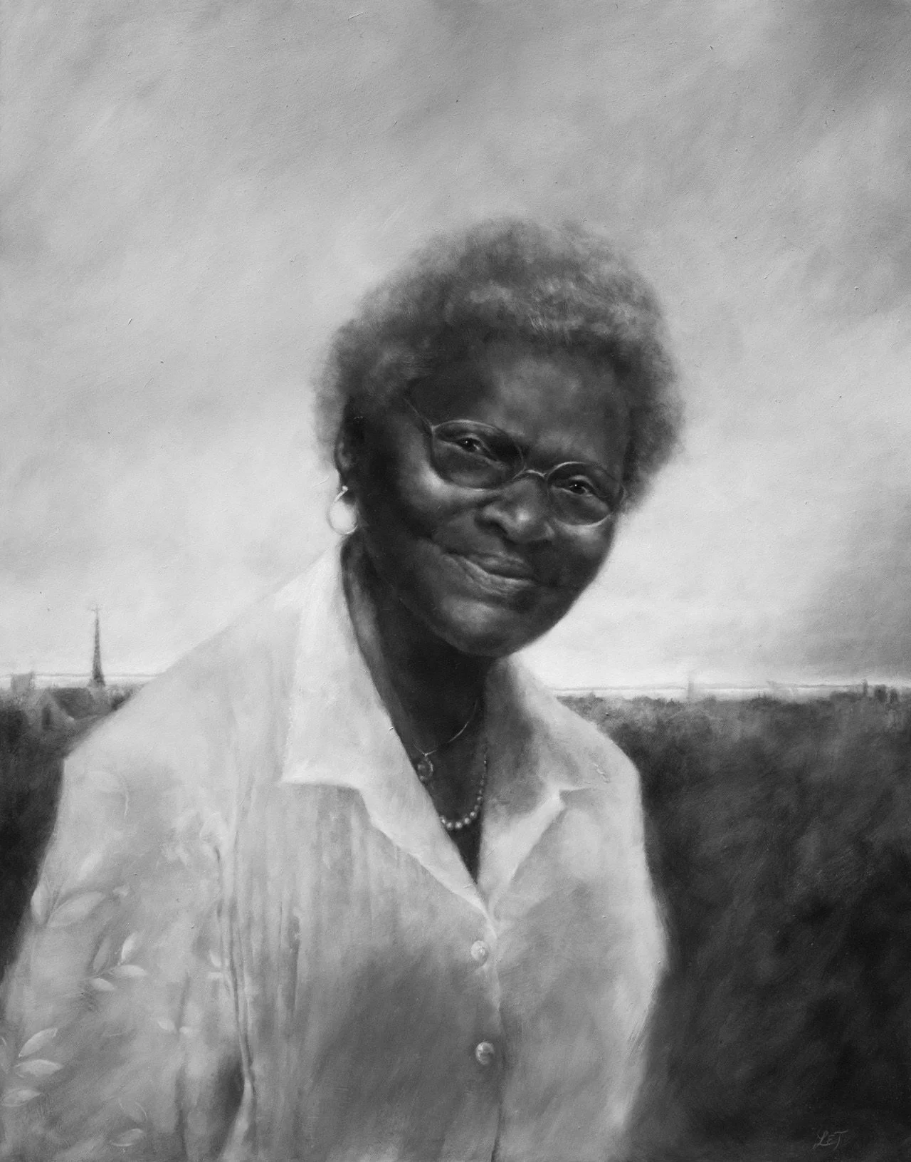 A young woman with black hair, smiling happily, wearing a blue shirt, surrounded by green plants in a bright indoor setting.