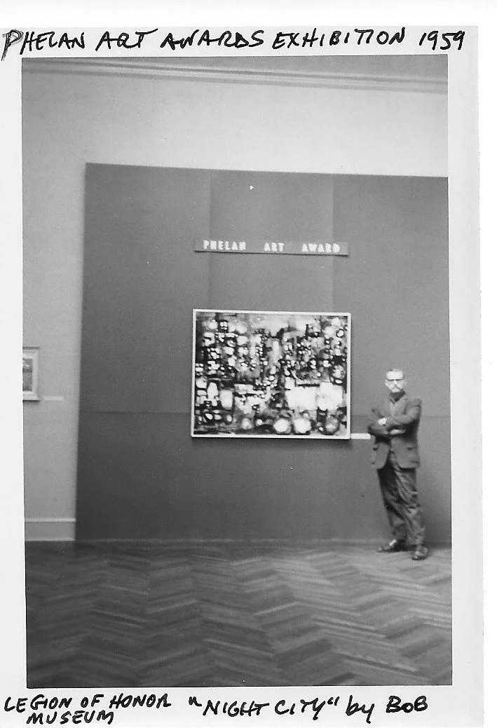 Photograph of Robert McClay at the Phelan Art Awards Exhibition 1959 standing next to his painting "Night City", winner of that year's "Phelan Art Award." The photo is black and white.