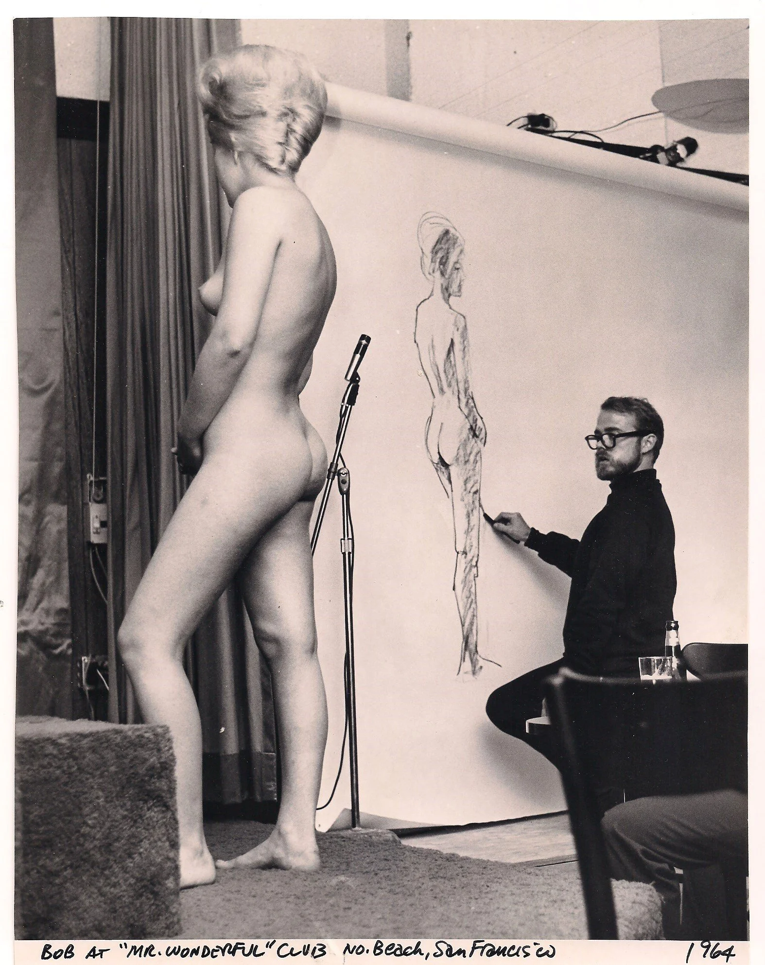 Photo of Robert McClay sketching a nude model for a nightclub act at "Mr. Wonderful" club in San Francisco in 1964.