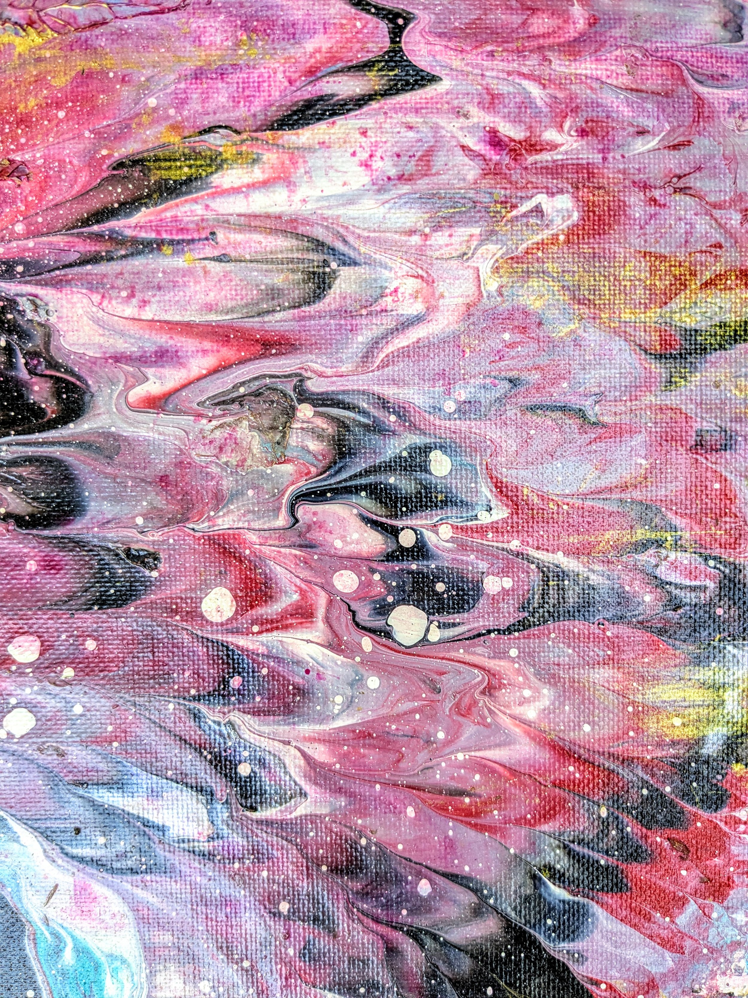 Abstract painting with swirling pink, black, white, and hints of blue and yellow, featuring splattered paint and textured canvas visible.