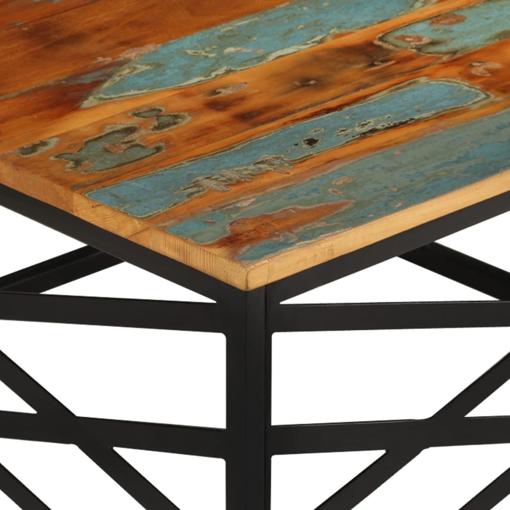 Close-up of a wooden tabletop with a blue and brown abstract design, supported by a black metal frame with geometric patterns.