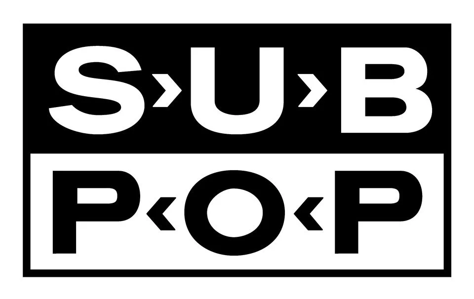 Black and white graphic featuring the words 'SUB' and 'POP' with arrows pointing inward and outward. Logo for SubPop Records.