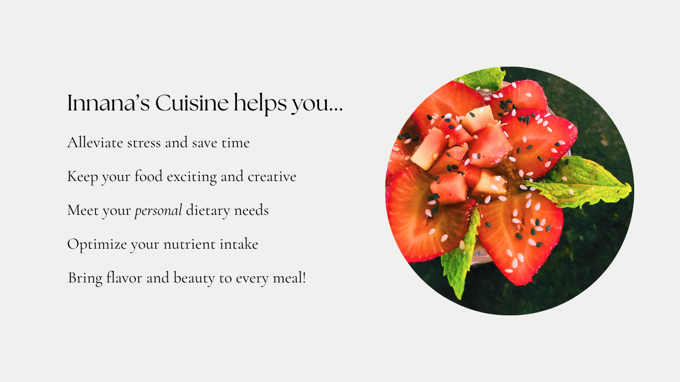 A circular dish containing a salad with sliced strawberries, small cubes of cheese, and sprinkled black and white sesame seeds, garnished with fresh mint leaves.