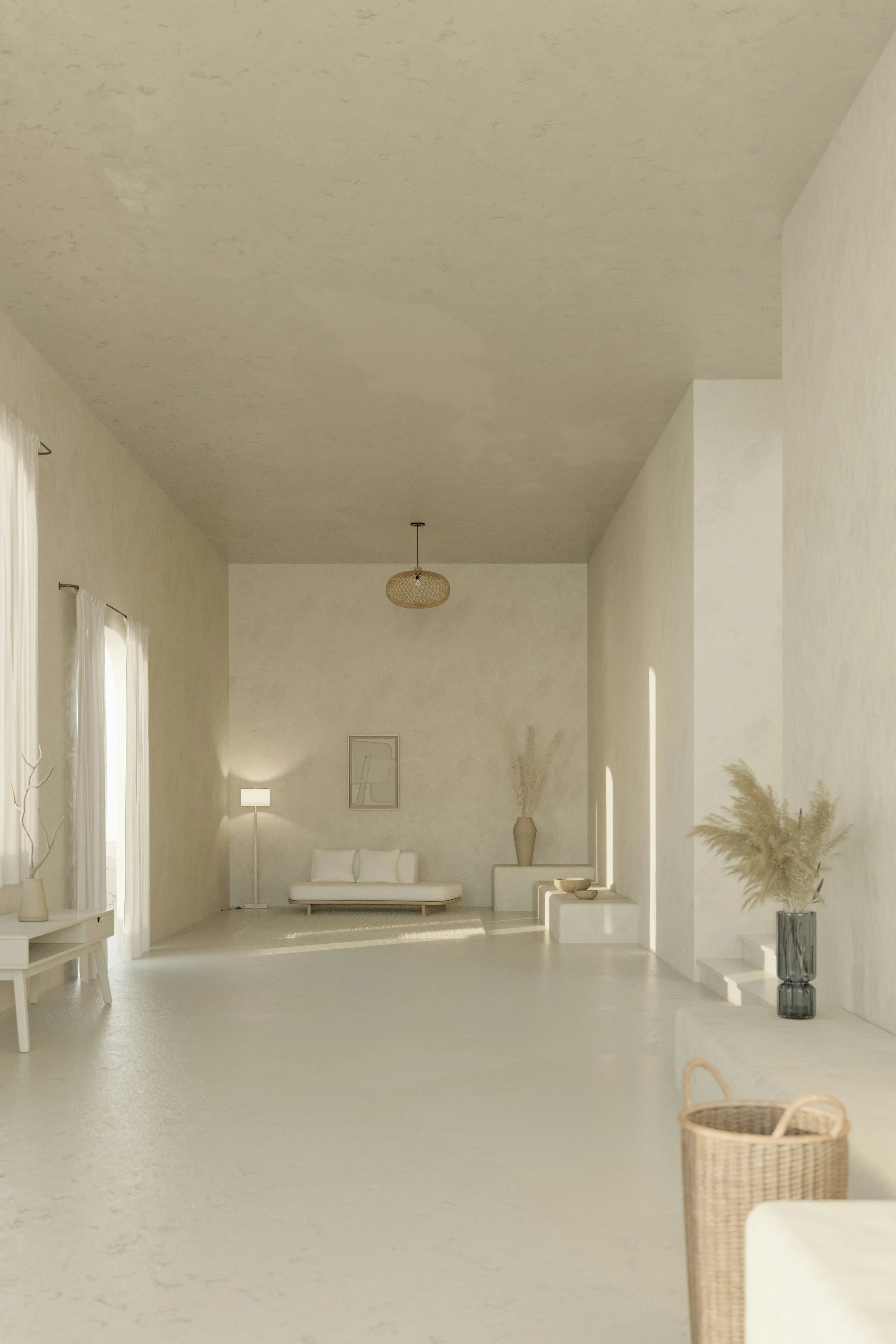 Minimalist living room with white walls and furniture, includes a white couch, a floor lamp, a large vase with dried plants, and a small table with decorative items, illuminated by natural light.