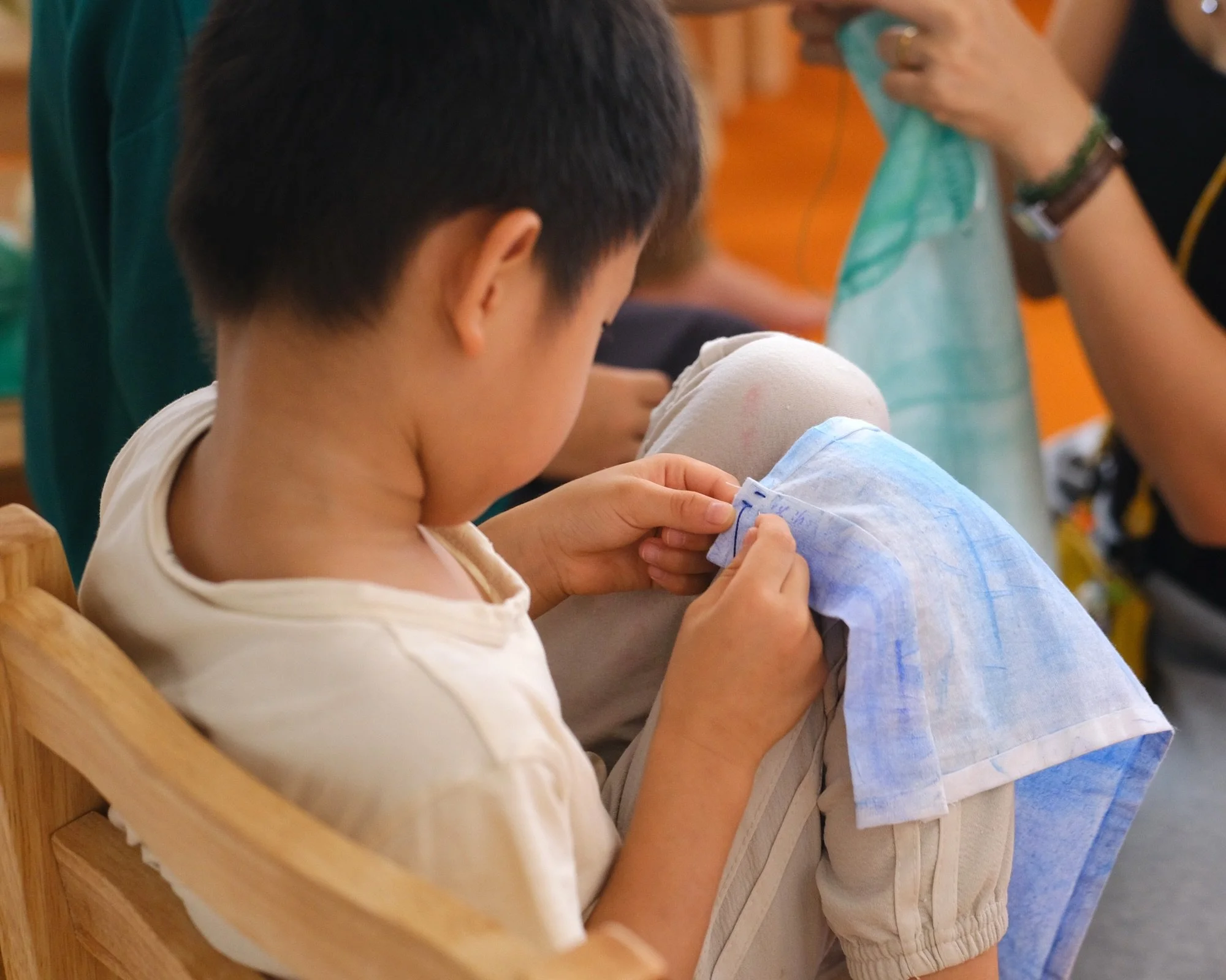 Children are familiarised with hand sewing techniques as early as 7 years old. As they focus on the thread, needle and cloth that were handed to them for different kinds of stitching, they learn to be gentle and purposeful with their fingers, wrists 