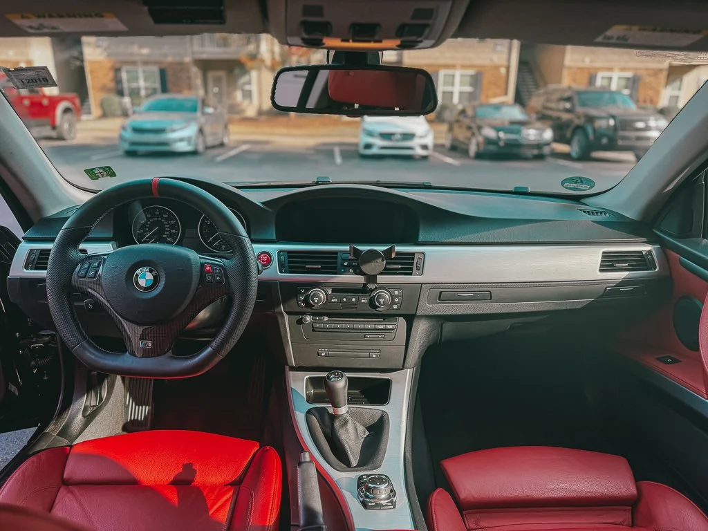 Luxury BMW interior after professional car detailing with red leather seats and clean dashboard in Harnett County NC