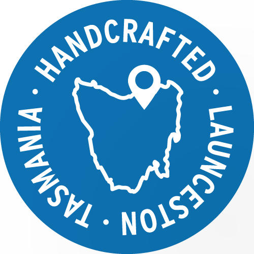 Blue circular logo with white text that reads "Handcrafted Laundestion Tasmania" around the perimeter, featuring a white outline map of Tasmania with a location pin in the center.