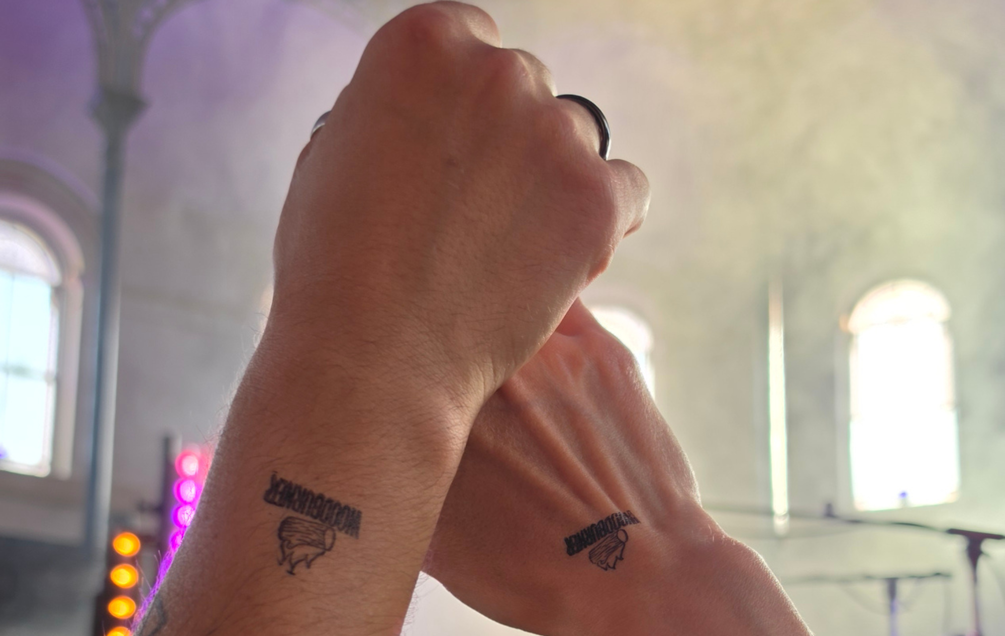Two hands are pointing upwards showing freedom in a big chapel