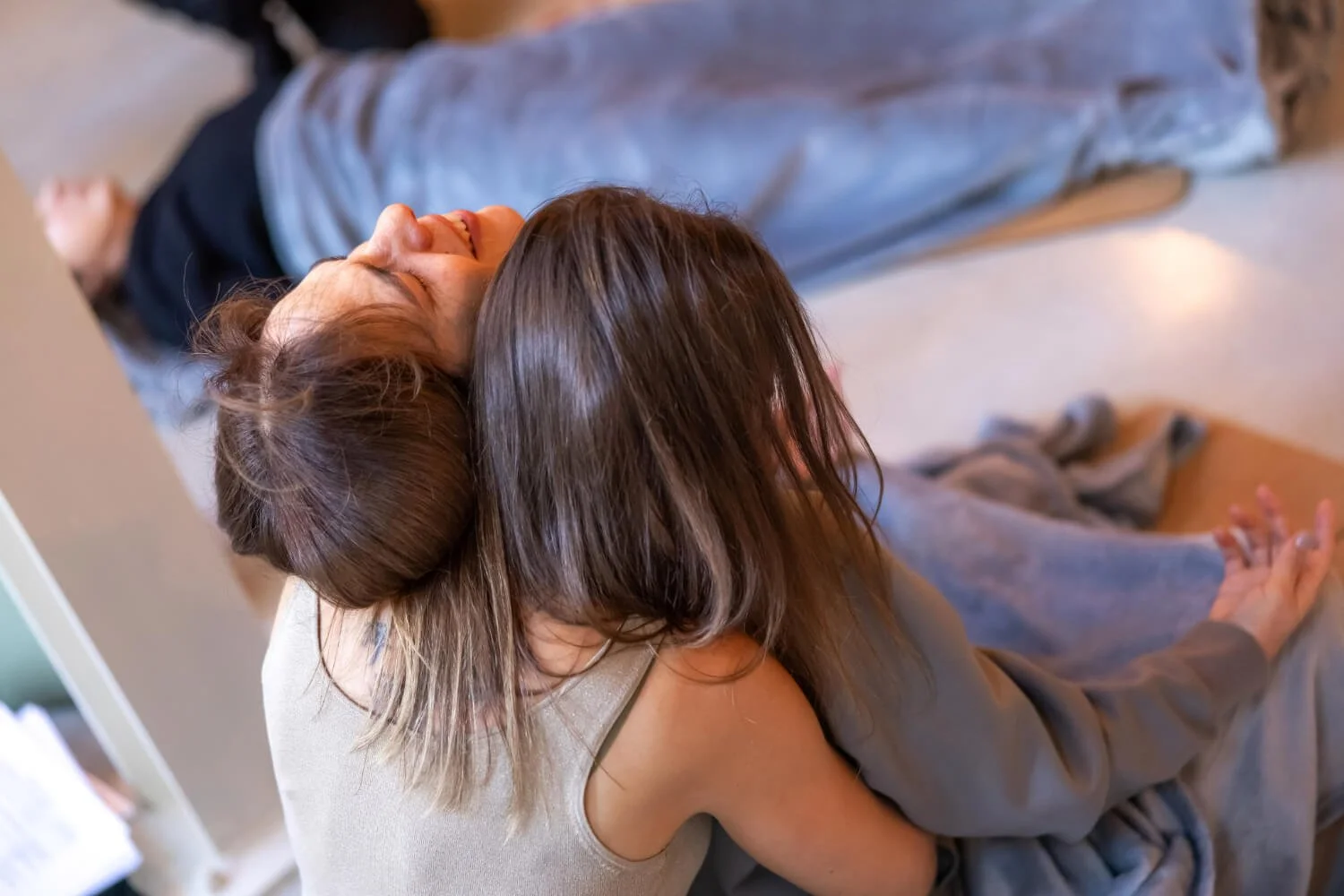 One woman is crying and being safely held by another woman in a vey loving manner